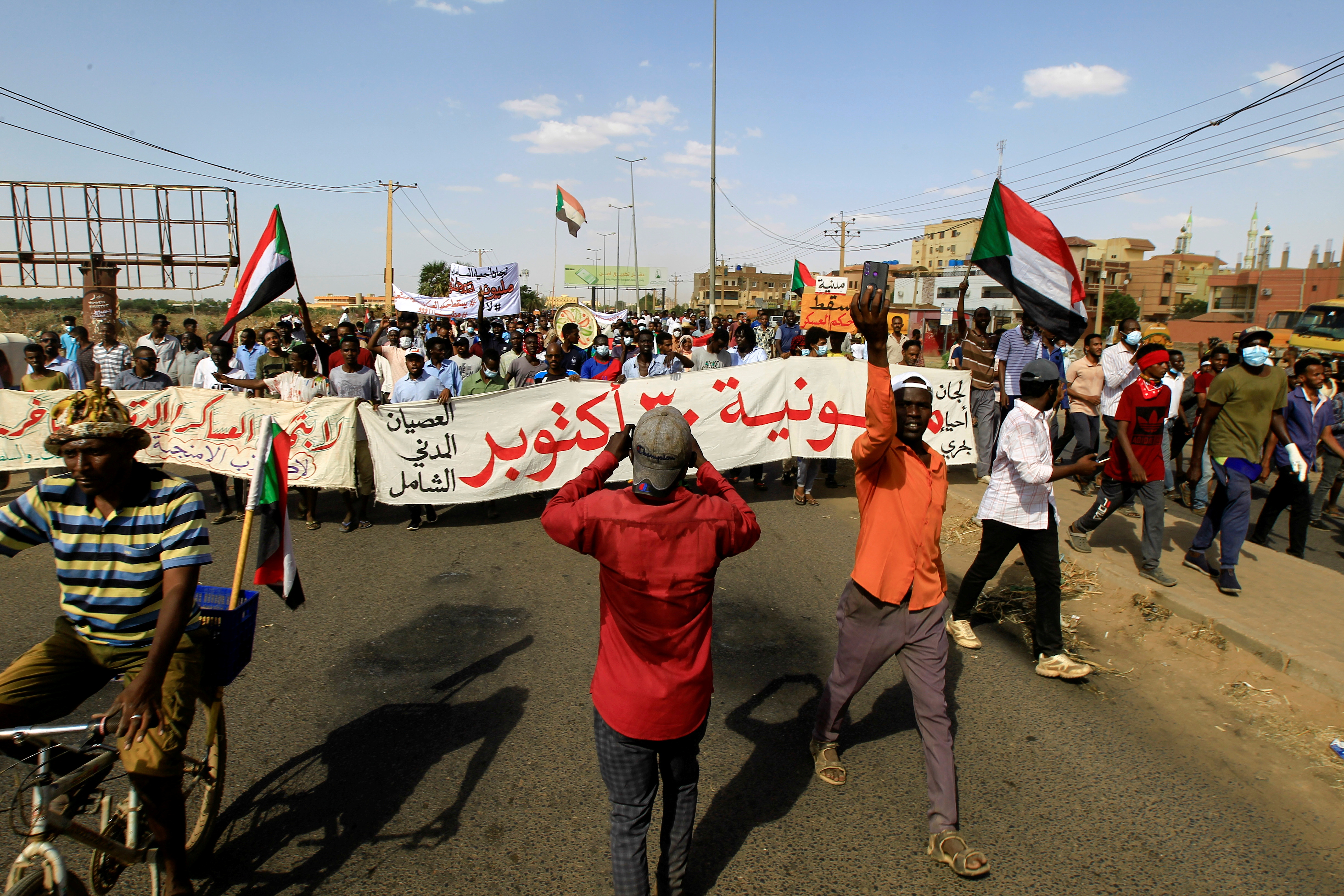 Protesters march against the Sudanese military's recent seizure of power and ousting of the civilian government, in the streets of the capital Khartoum on October 30, 2021 [Reuters/Mohamed Nureldin]