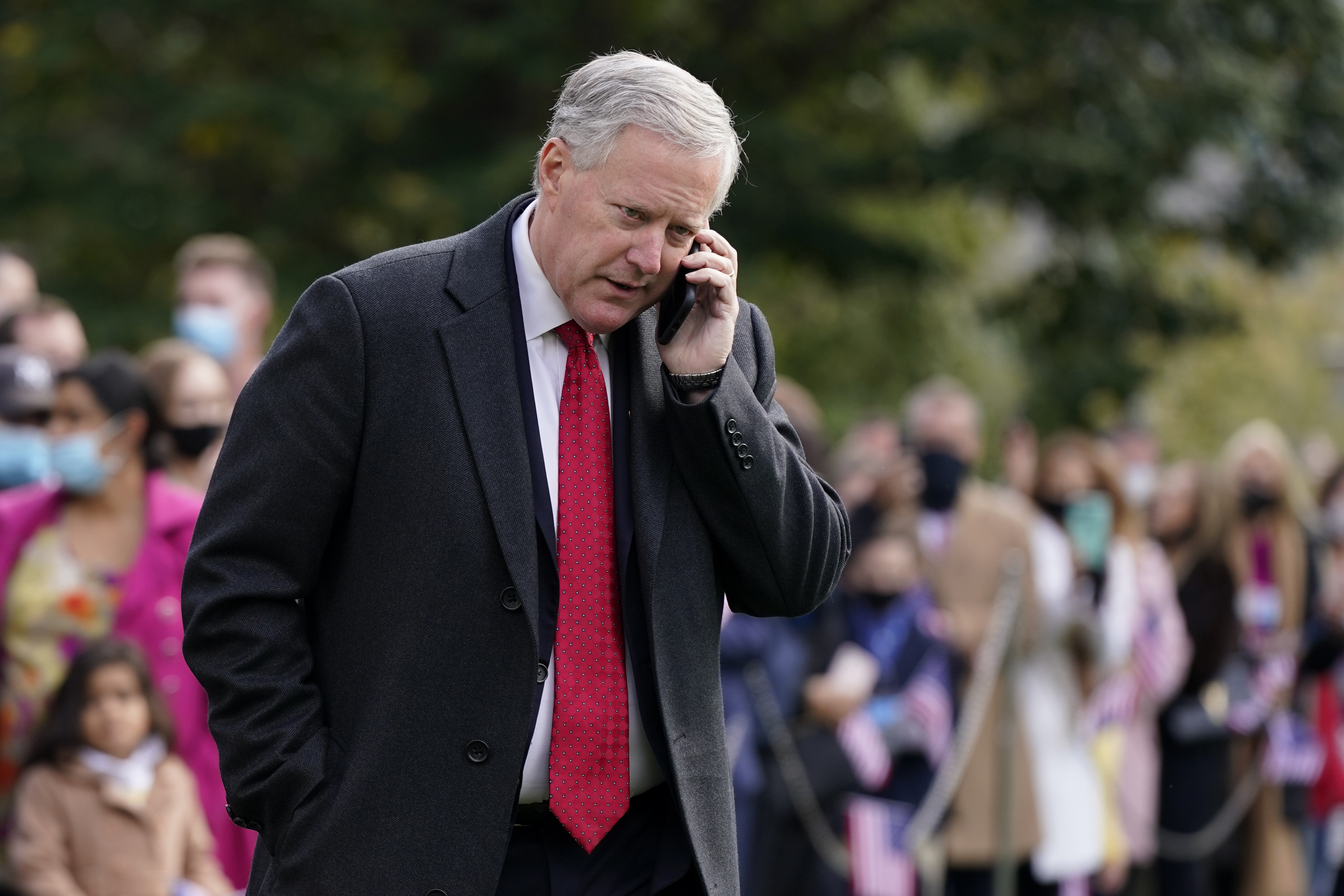 White House chief of staff Mark Meadows speaks on a phone on the South Lawn of the White House.