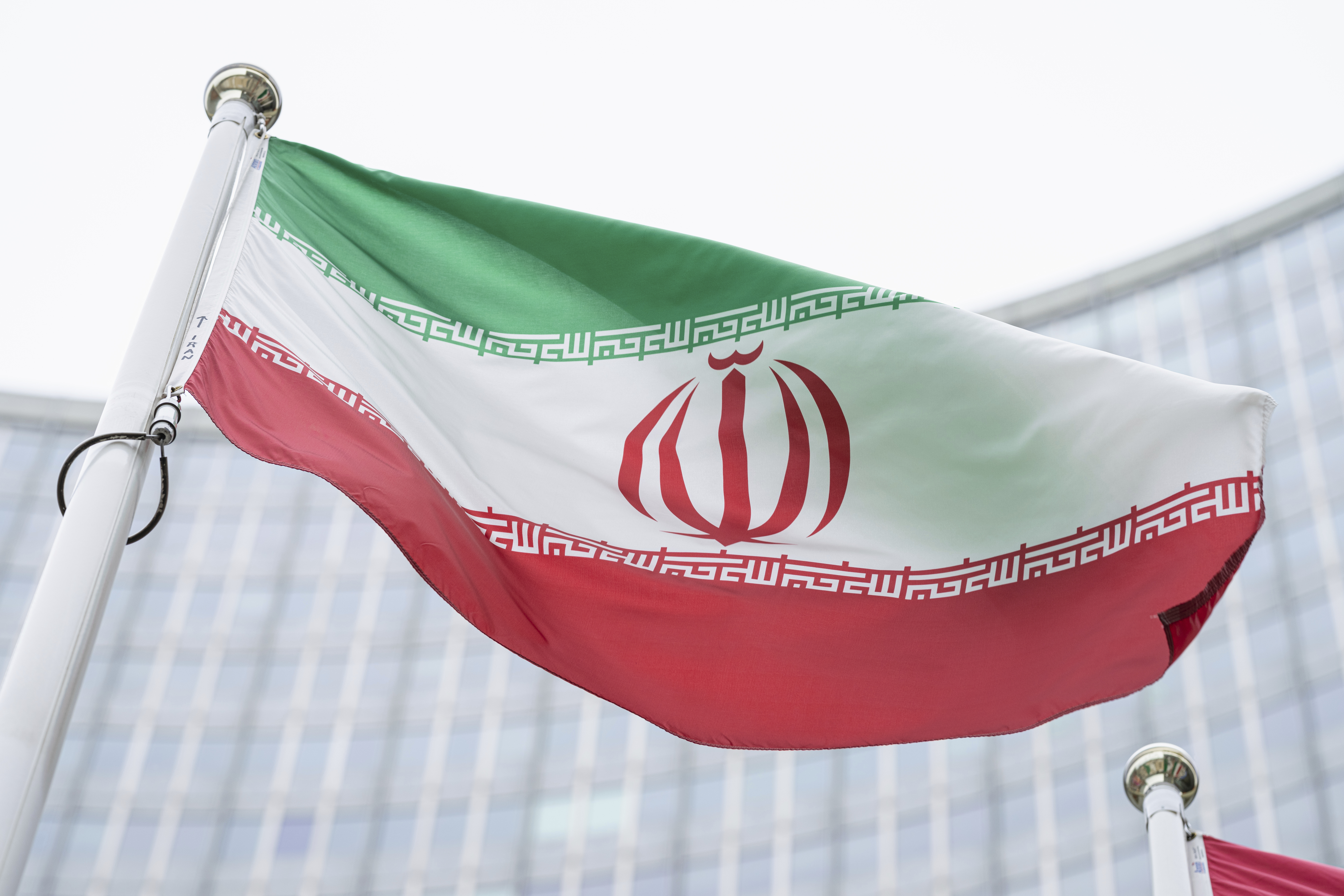 The flag of Iran waves in front of the the International Center building with the headquarters of the International Atomic Energy Agency