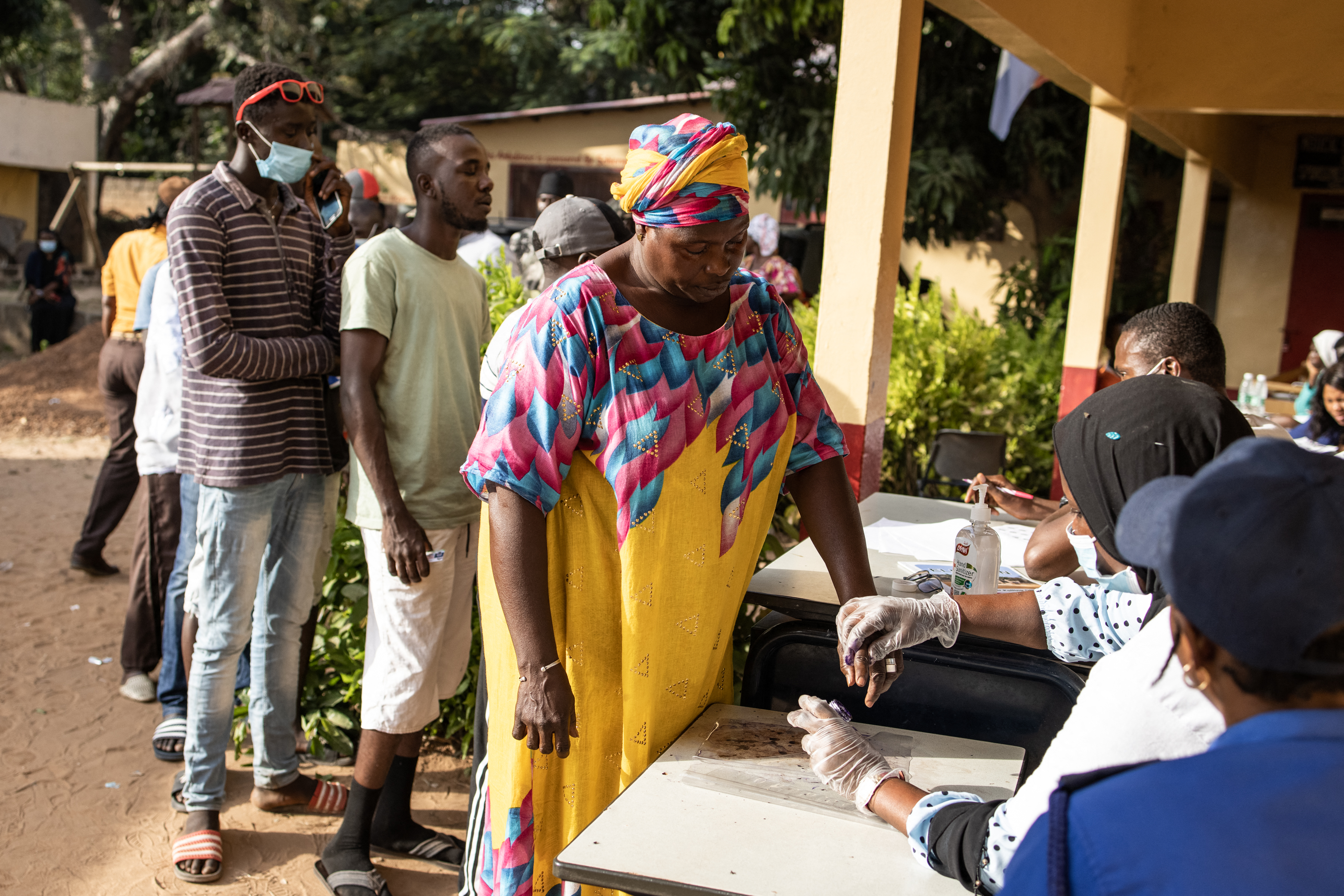 A woman gets her finger marked with ink before casting her vote in Banjul on December 4, 2021 [John Wessels/AFP]