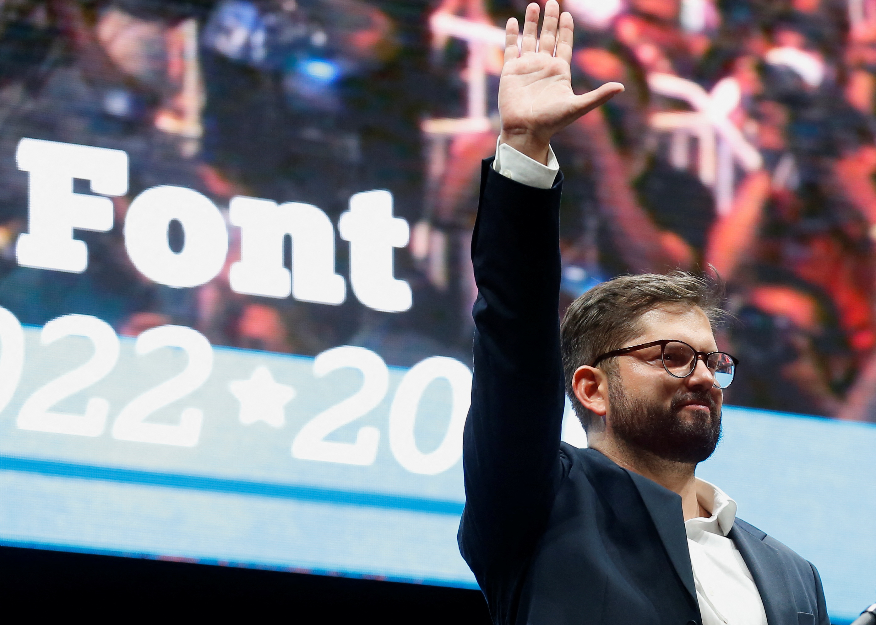 Chile's President-elect Gabriel Boric celebrates with supporters after winning the election in Santiago, Chile, December 19, 2021 [File: Rodrigo Garrido/Reuters]