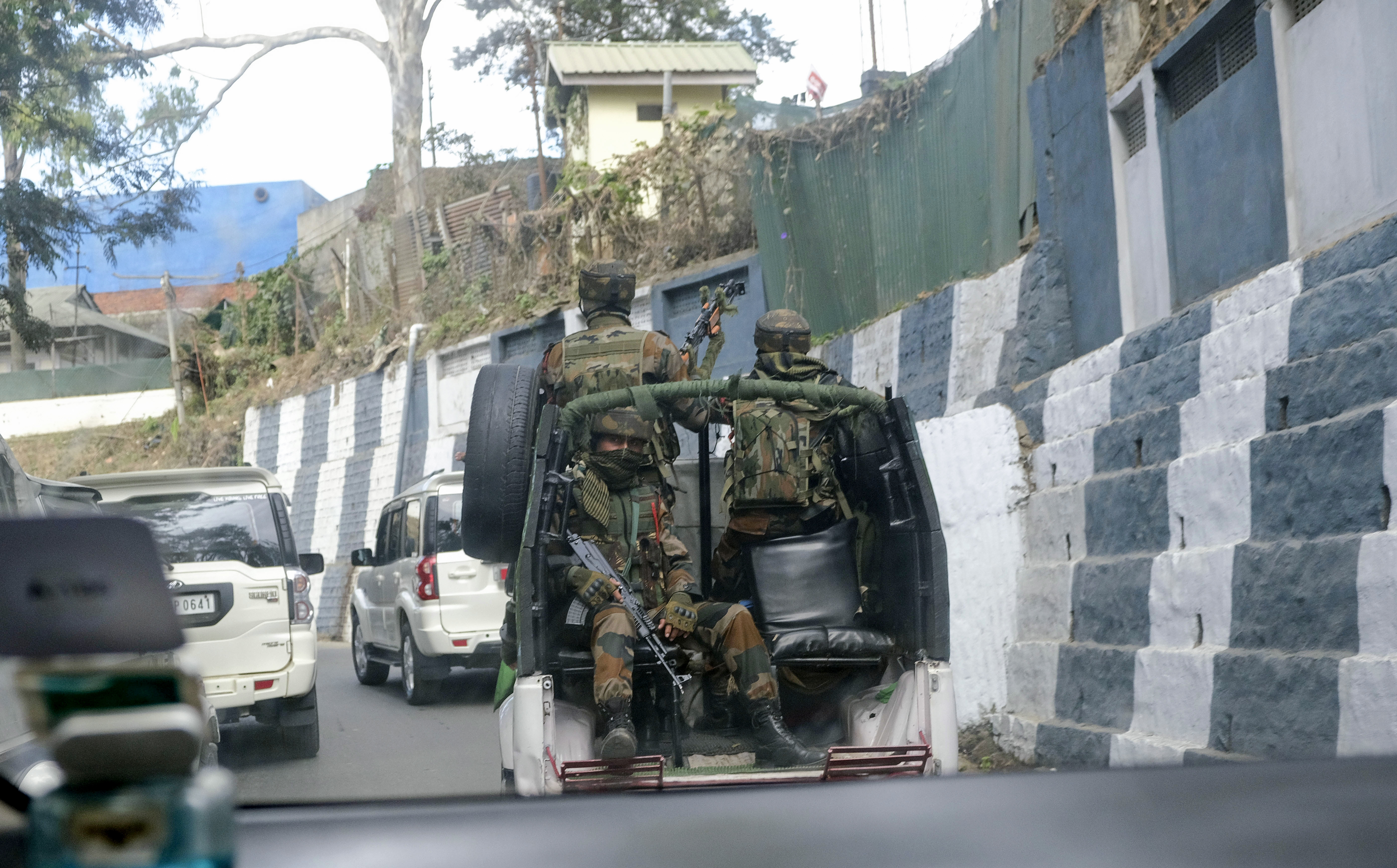 Indian army soldiers ride past the main town in a convoy in Kohima, capital of northeastern Nagaland state, India, Sunday, December 5, 2021 [Yirmiyan Arthur/AP Photo]