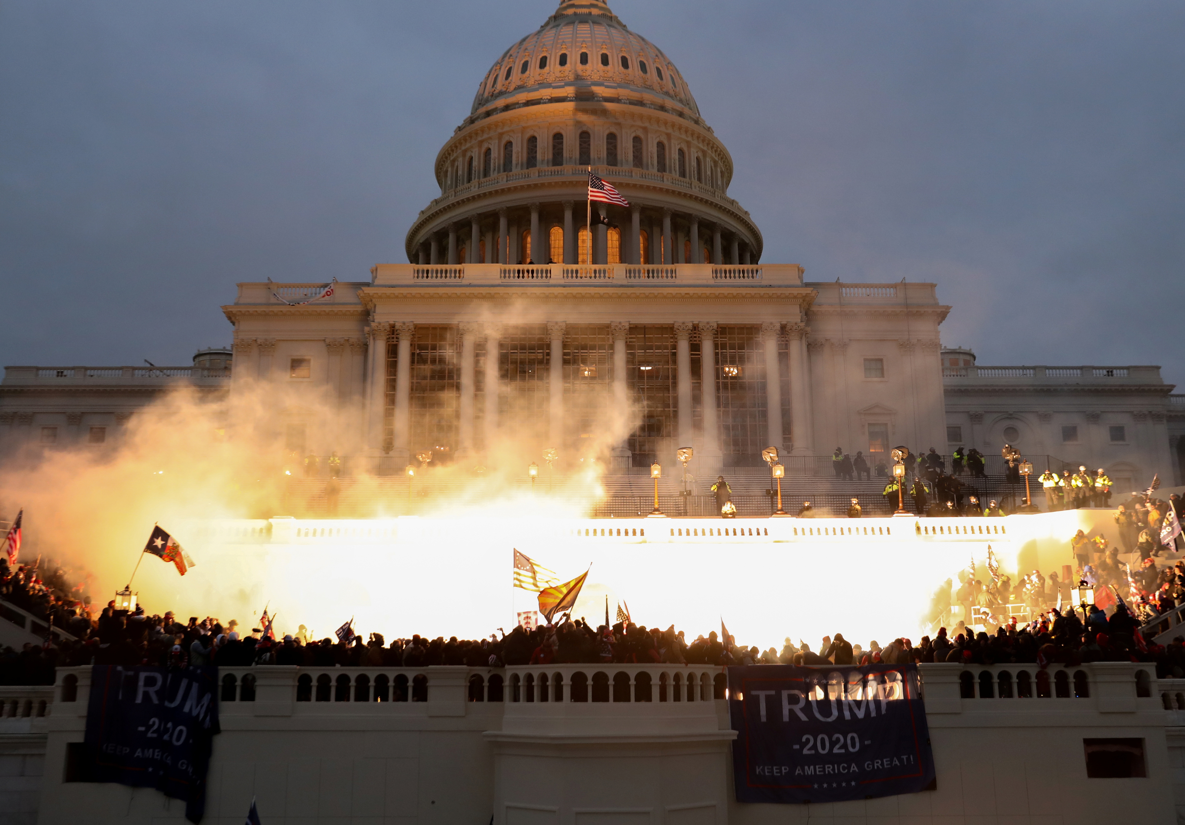An explosion caused by a police munition is seen while supporters of U.S. President Donald Trump riot in front of the U.S. Capitol Building in Washington,