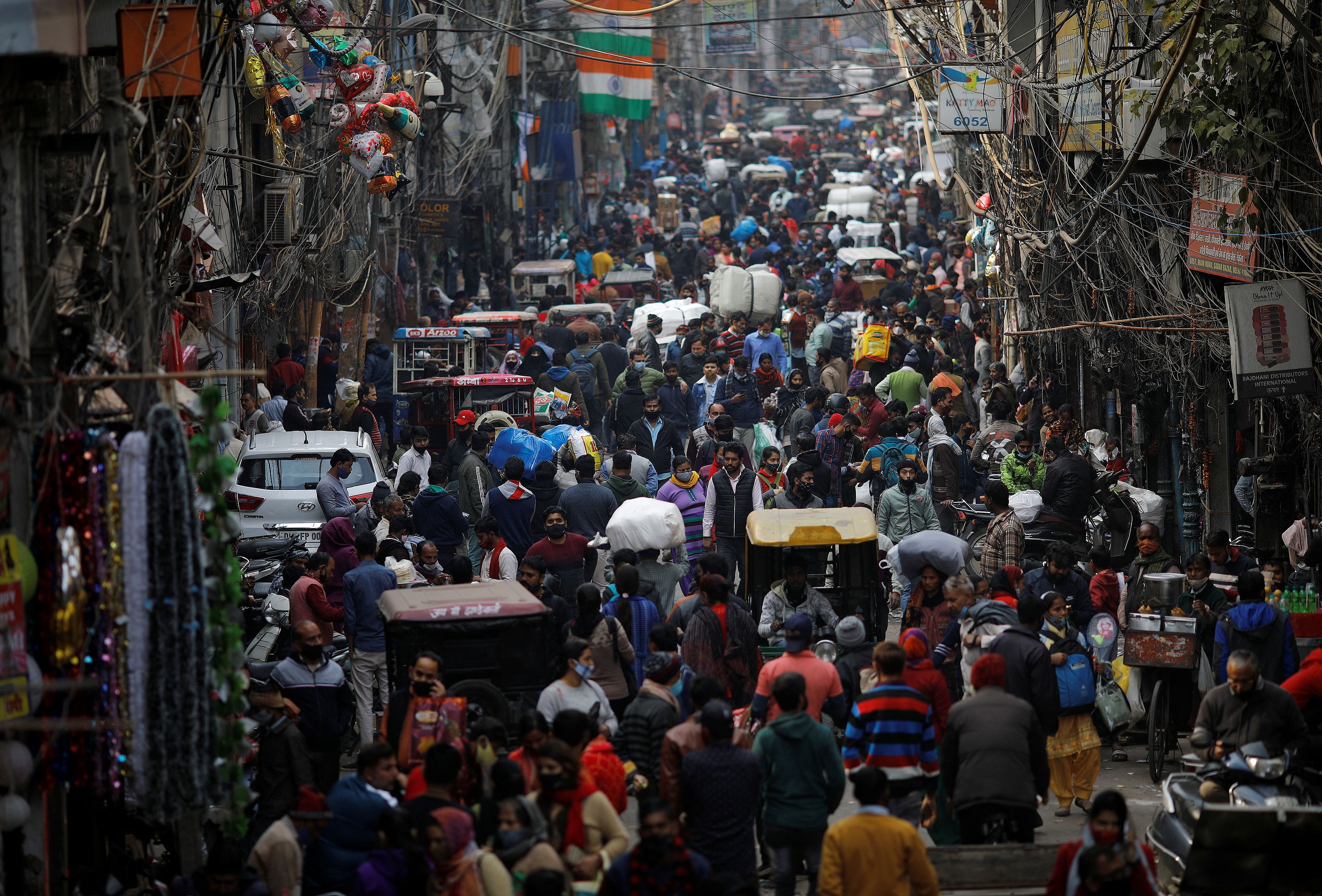 People shop at a crowded in the old quarters of New Delhi, India