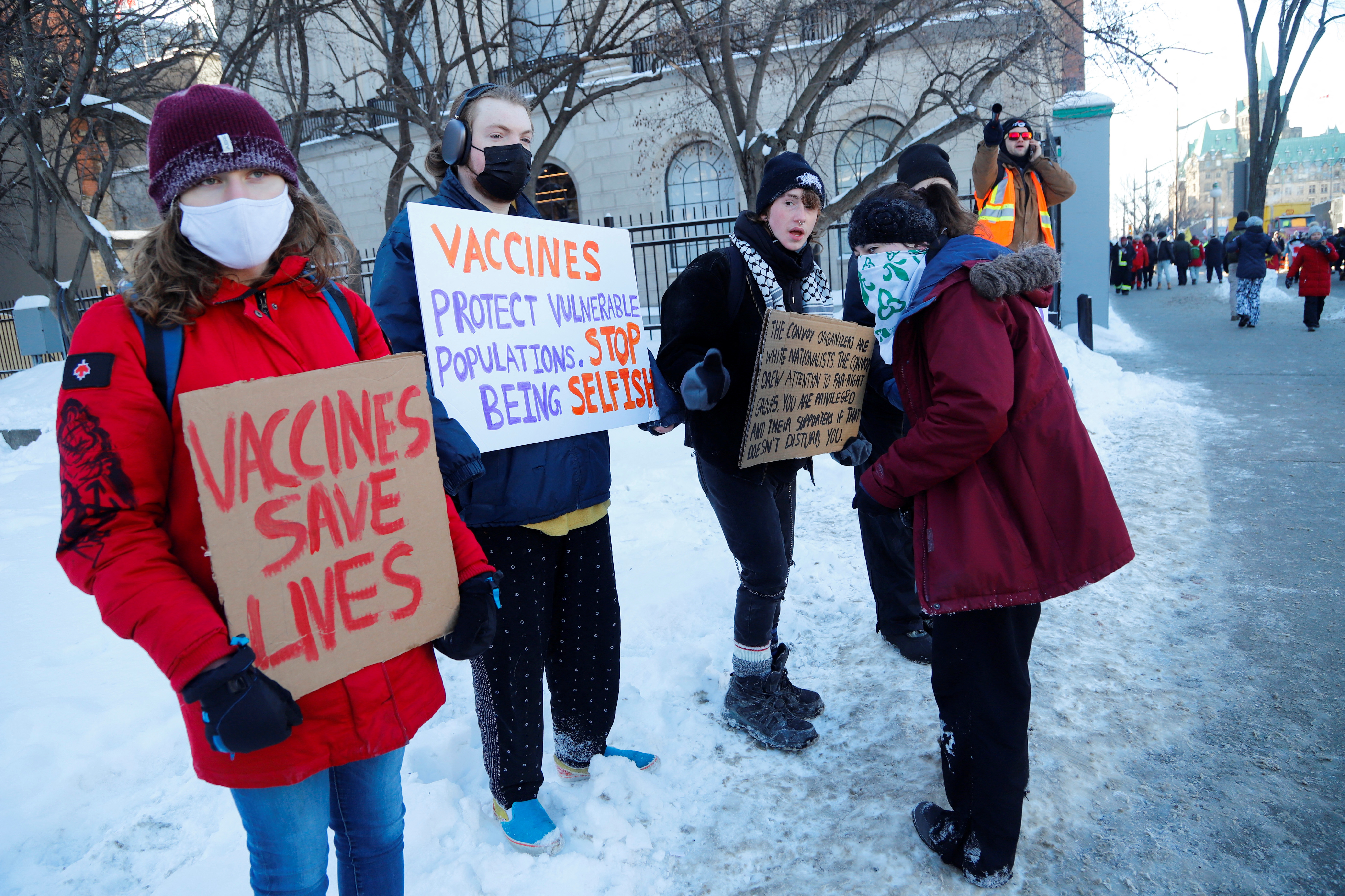 Counter protestors stand across from Parliament Hill as truckers take part in a convoy to protest coronavirus disease (COVID-19) vaccine mandates