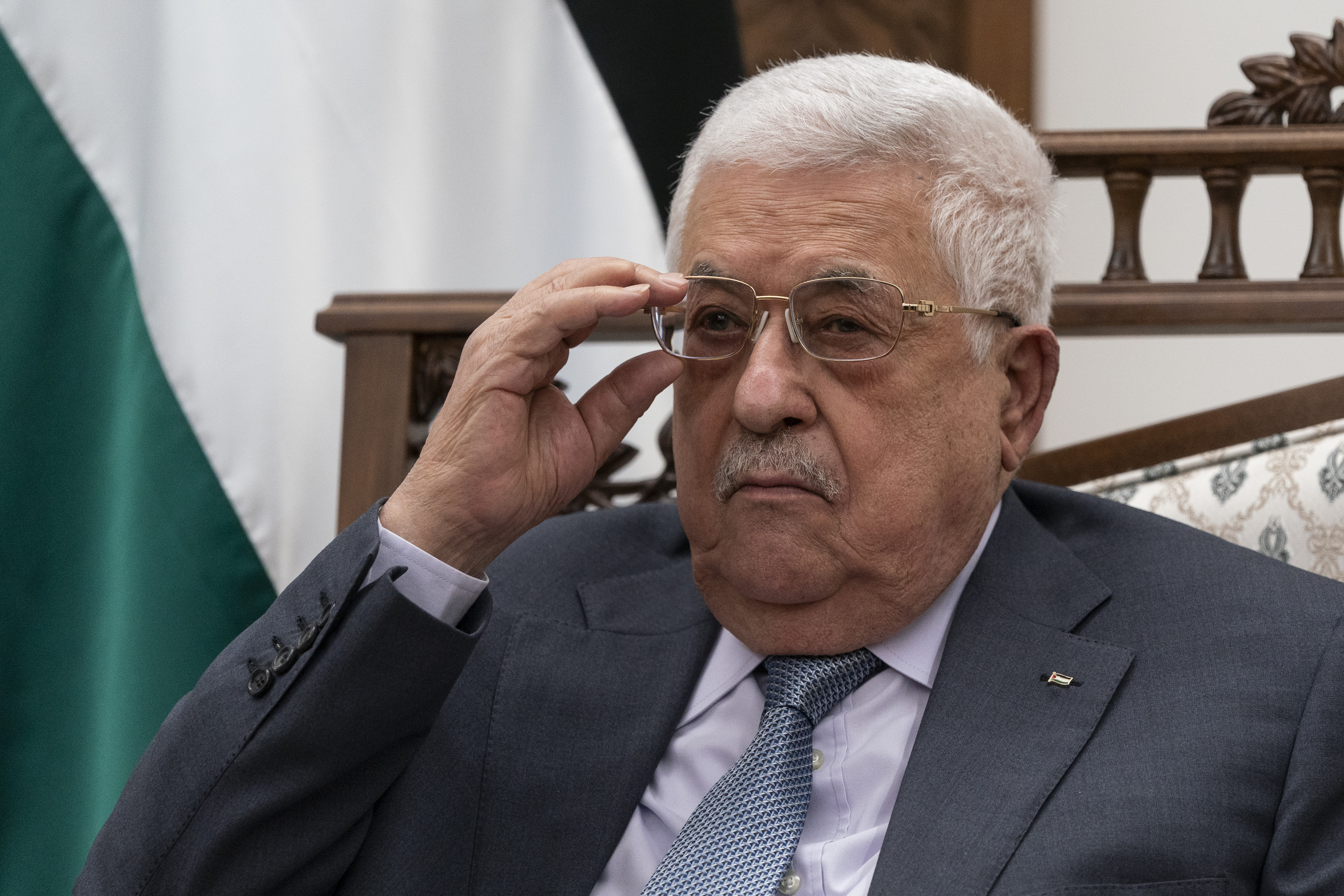 Palestinian President Mahmoud Abbas adjusts his glasses as he listens during a joint statement with Secretary of State Antony Blinken, Tuesday, May 25, 2021, in West Bank city of Ramallah. Abbas met with Israeli Defense Minister Benny Gantz at Gantz's private residence in a Tel Aviv suburb late Tuesday, Dec. 28, 2021. The two discussed security coordination