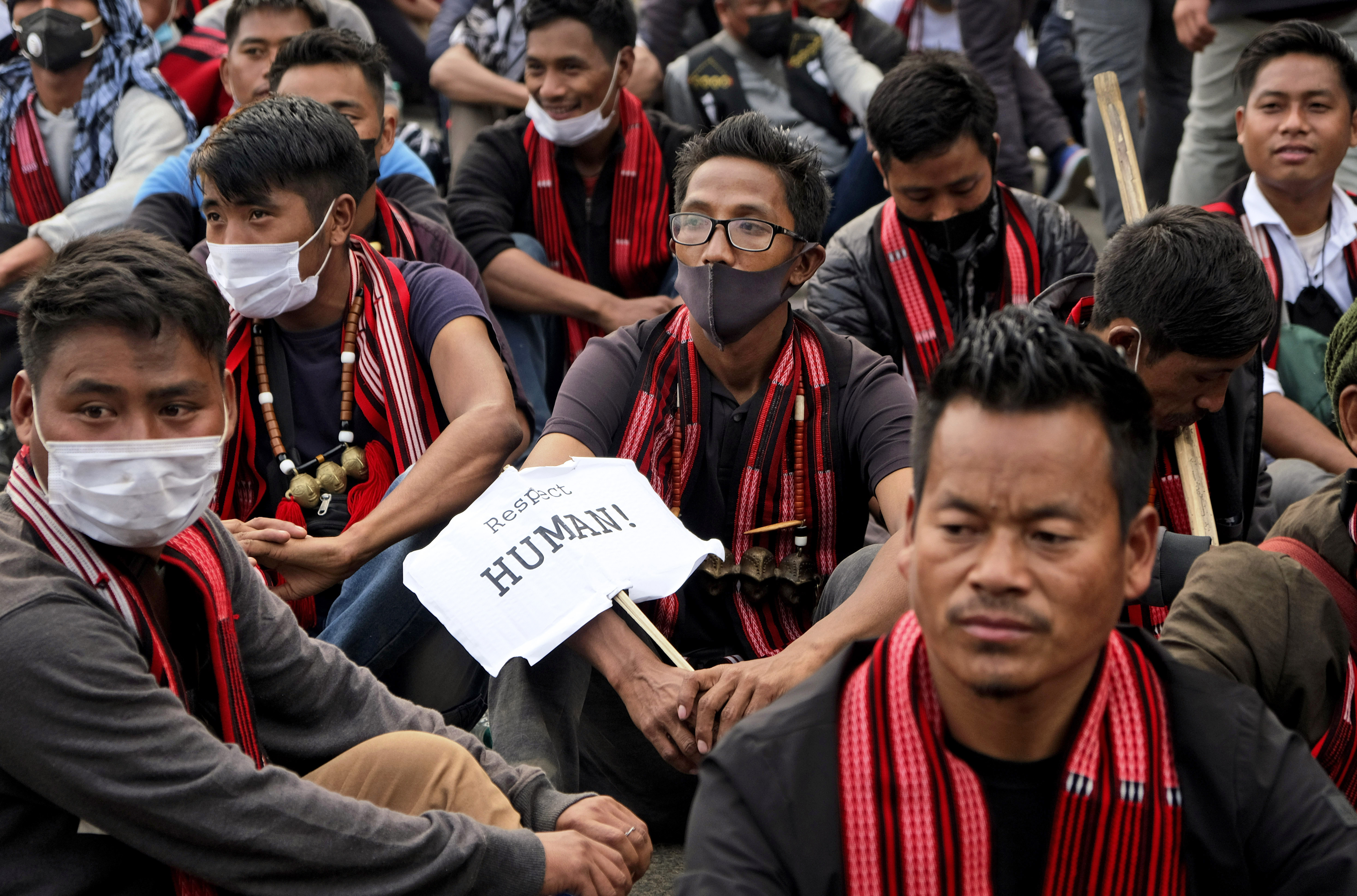 Nagas at the protest - one man holds a placard with word: "Human!"