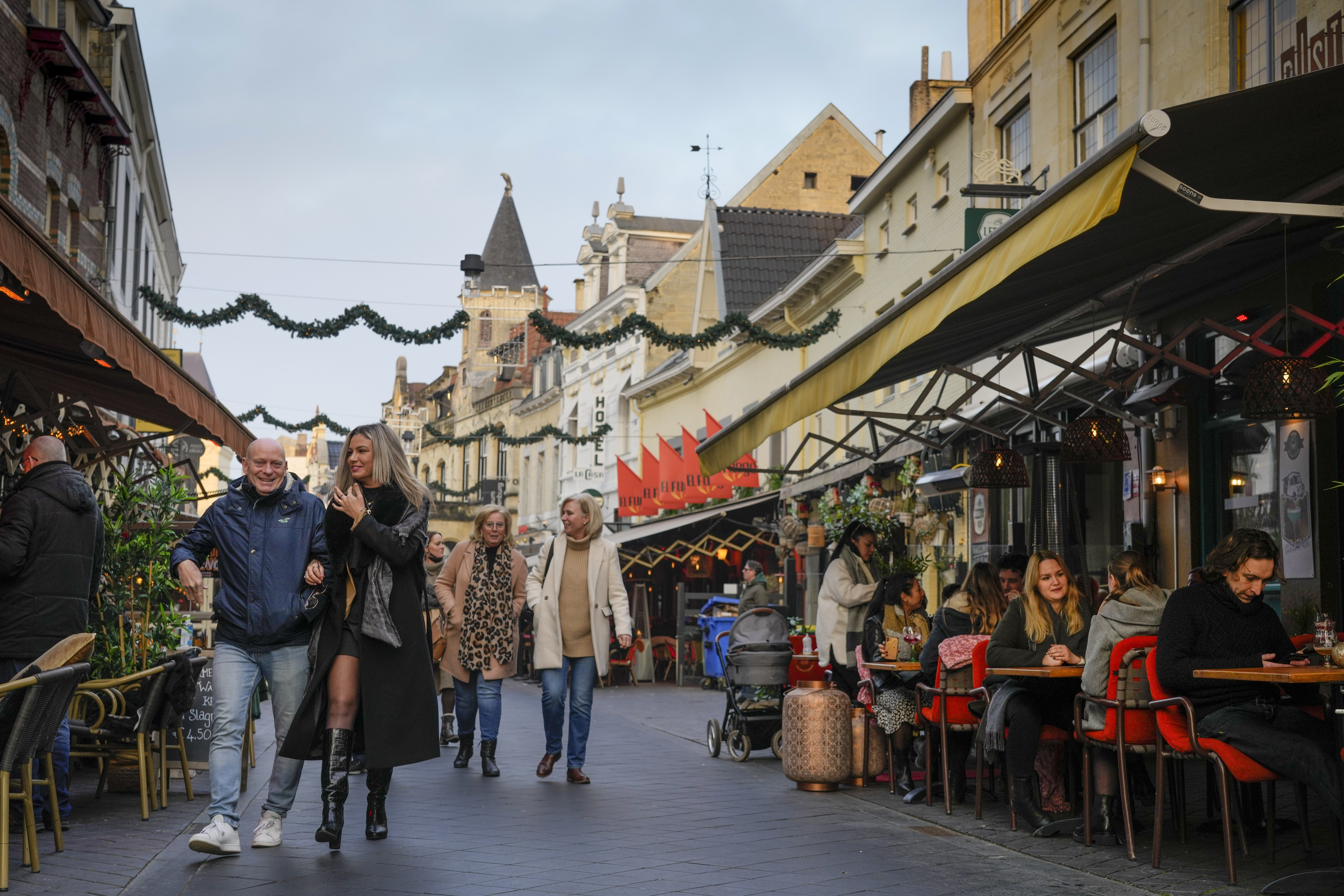 People are seen sitting at bars and walking along the boulevard outside in Valkenburg, southern Netherlands