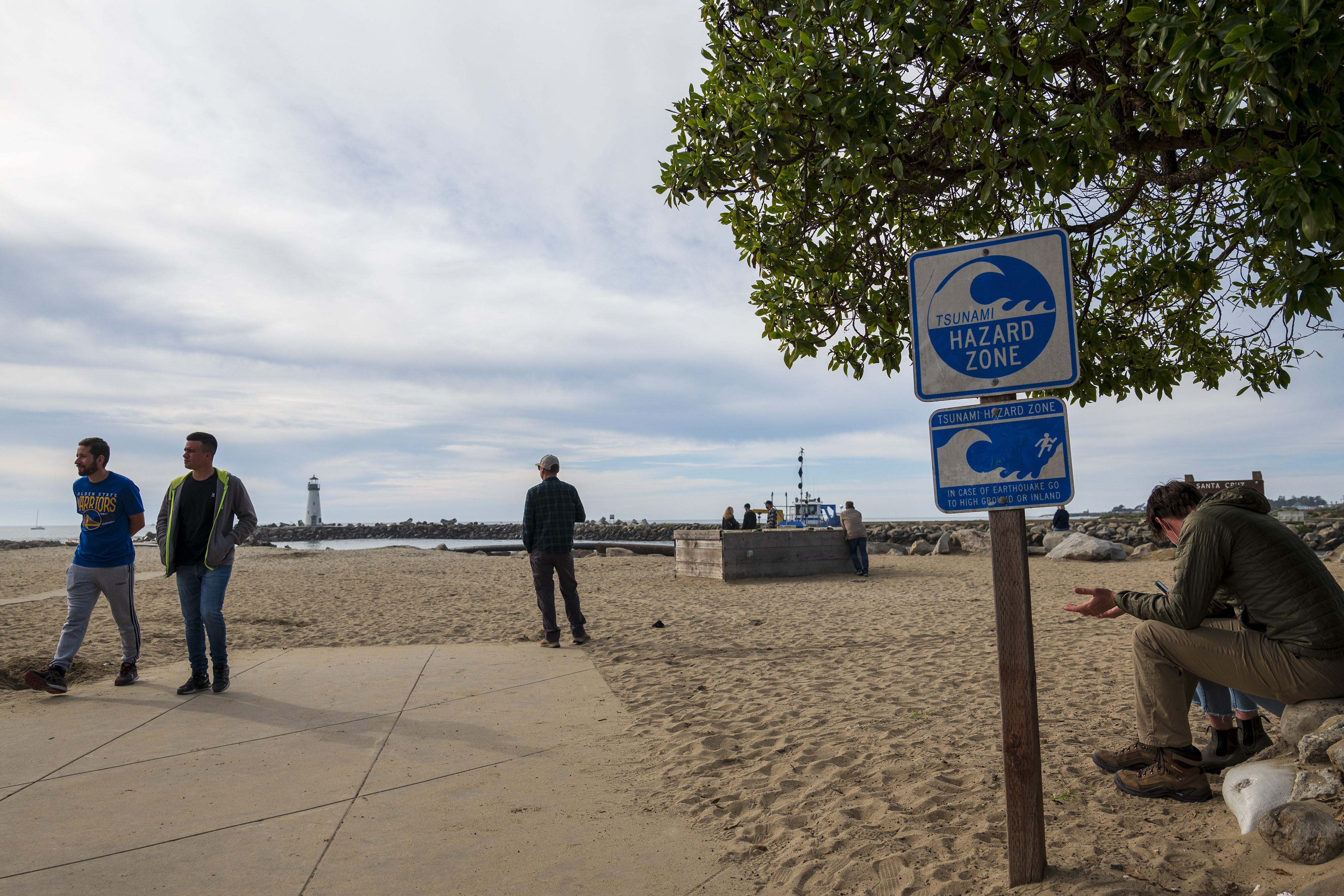 People watch waters rise from Twin Lakes State Beach in Santa Cruz