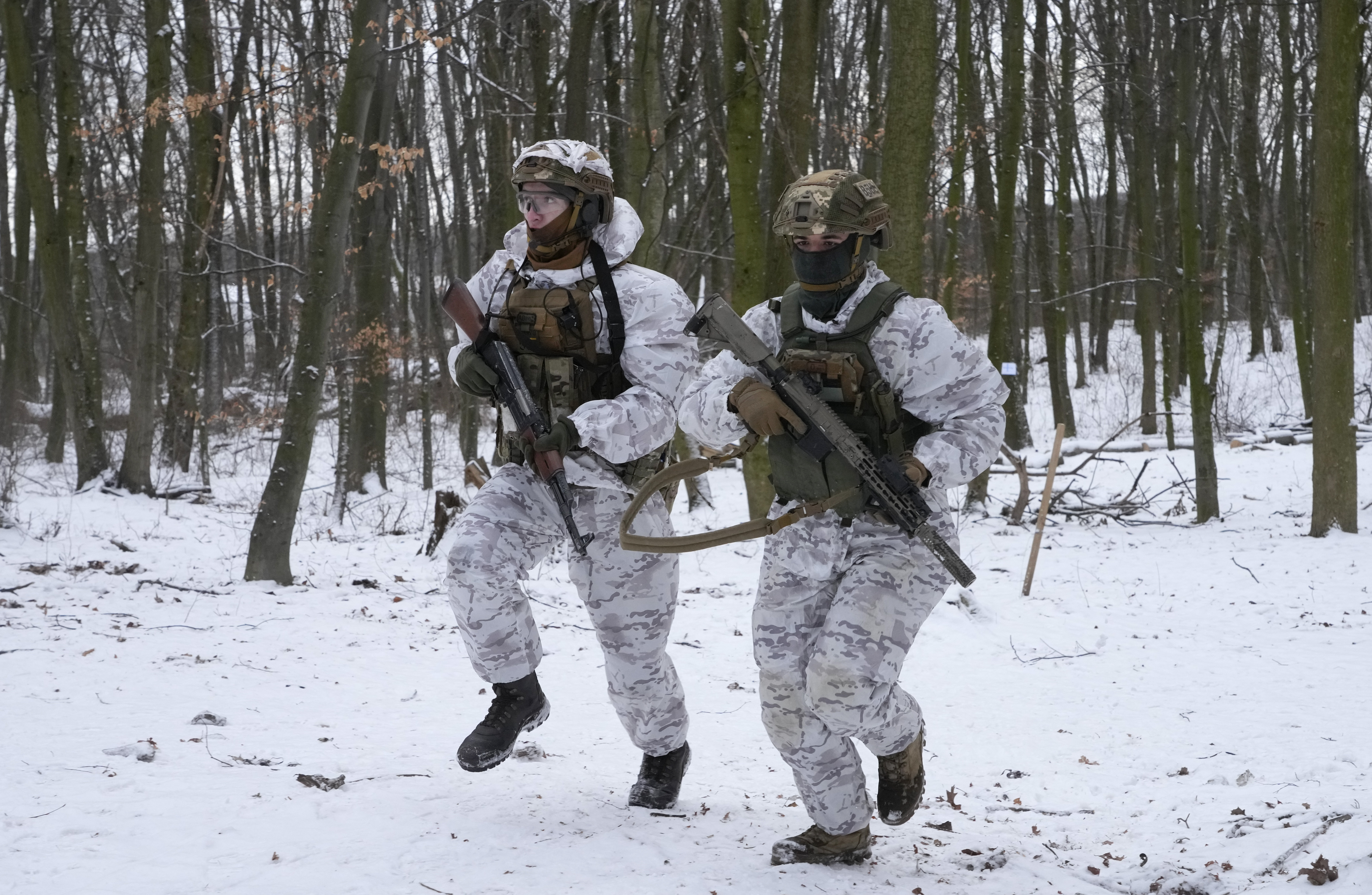 Members of Ukraine's Territorial Defense Forces, volunteer military units of the Armed Forces, train in a city park in Kyiv