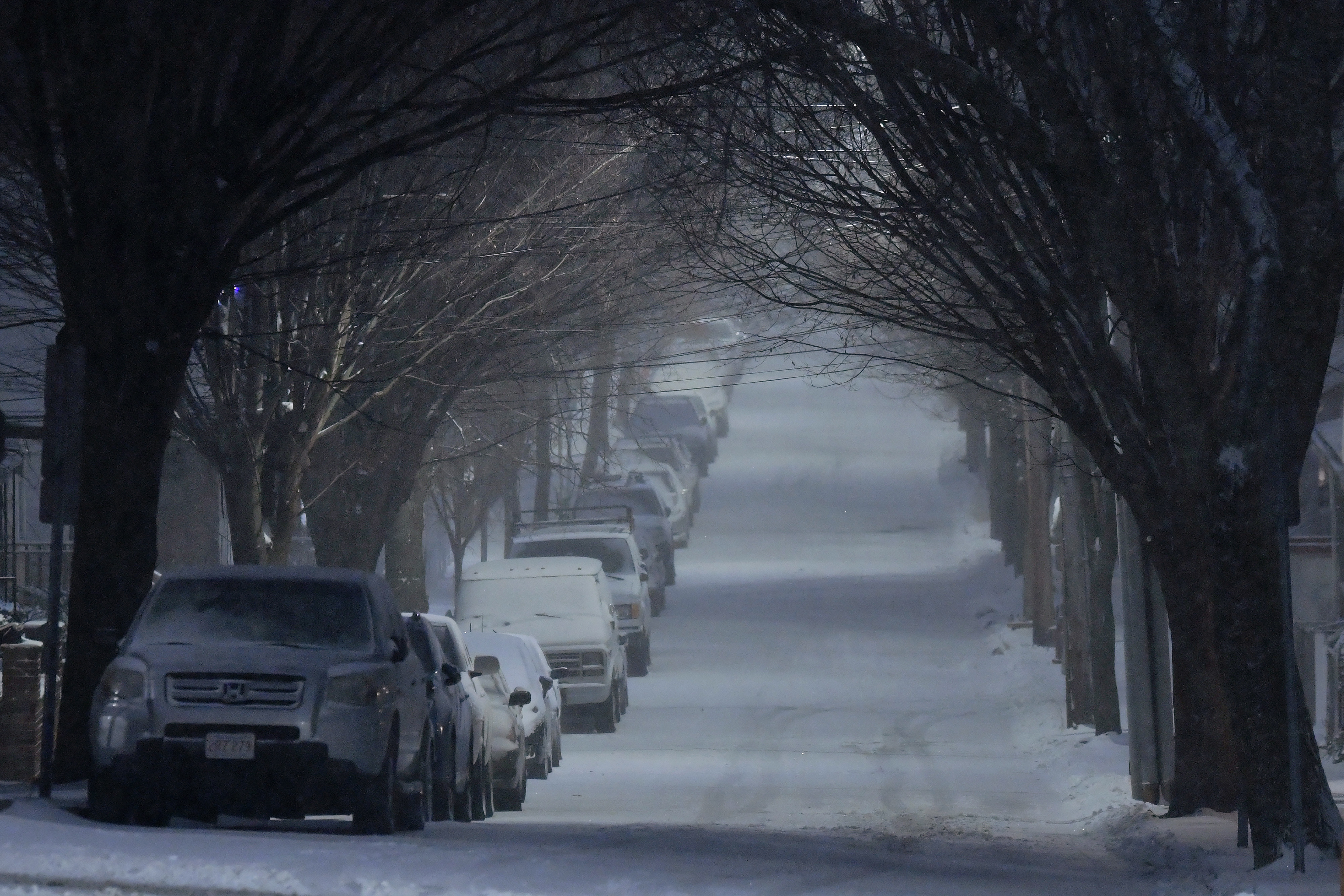 A dusting of snow falls at dawn as the beginning of a major snow storm arrive