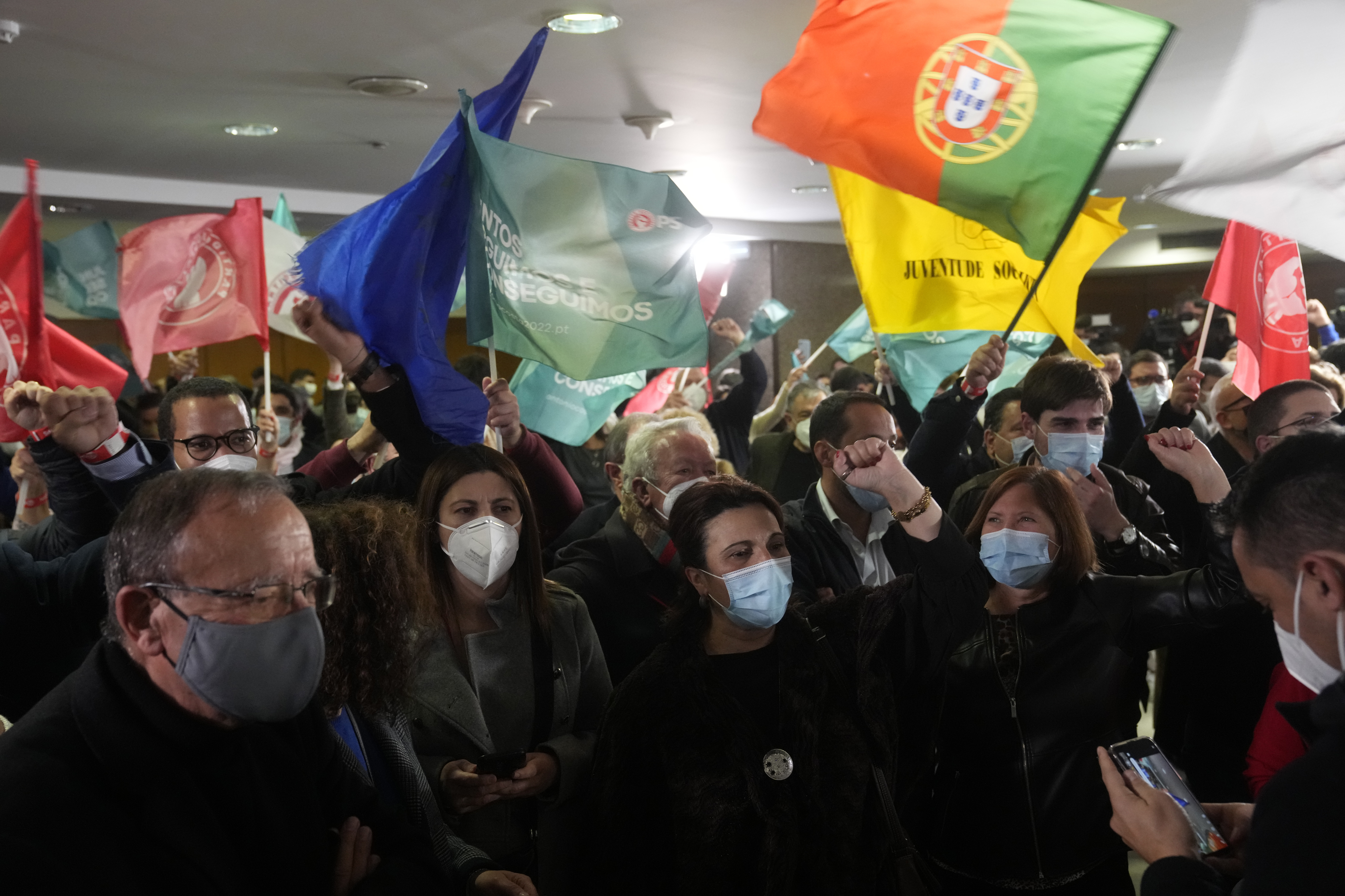 Socialist party supporters - men and women - wave Portuguese and EU flags after exit polls revealed a strong performance for the party