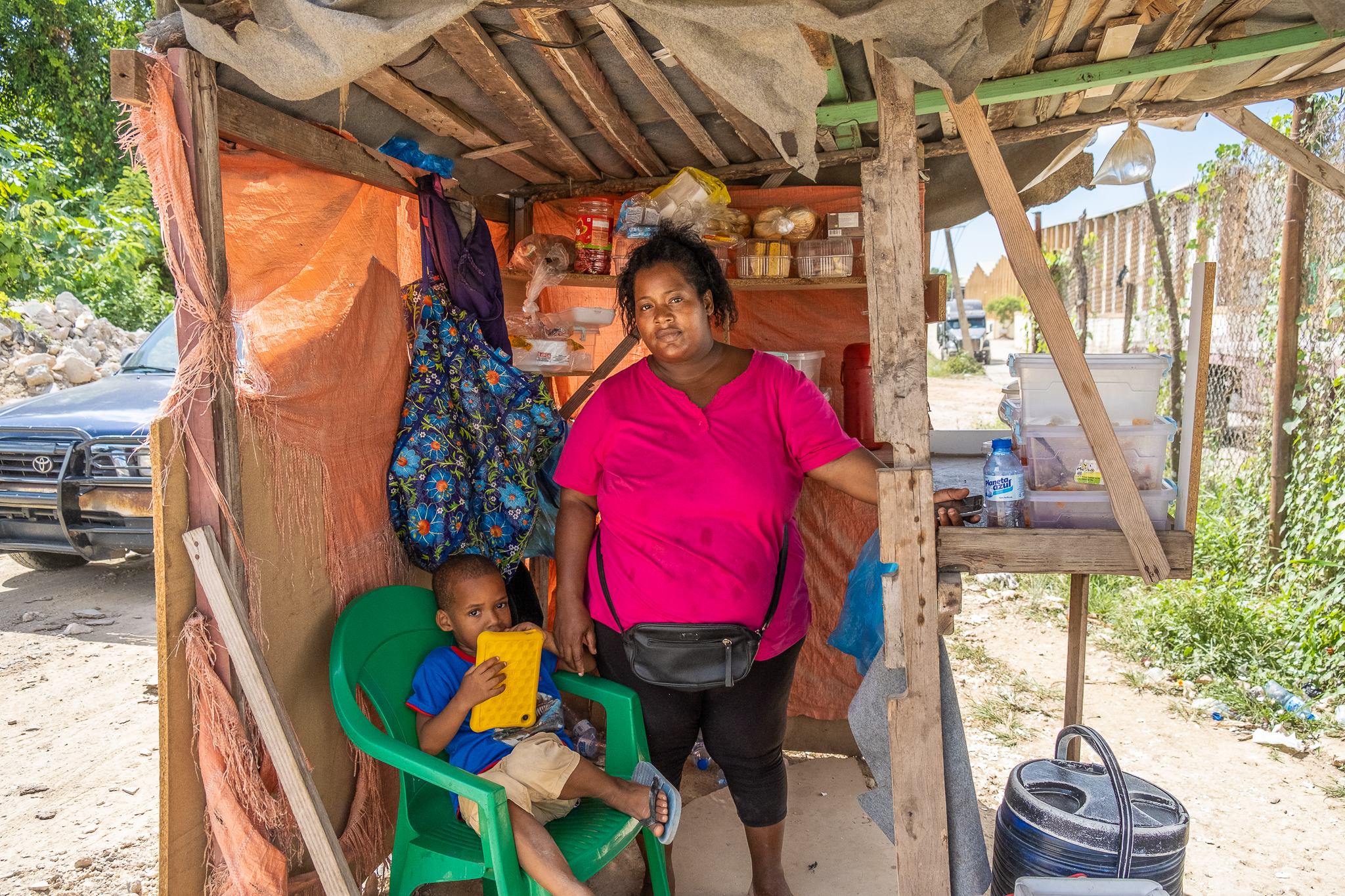 Santa Frias stands near her small shop in Haina's industrial zone.