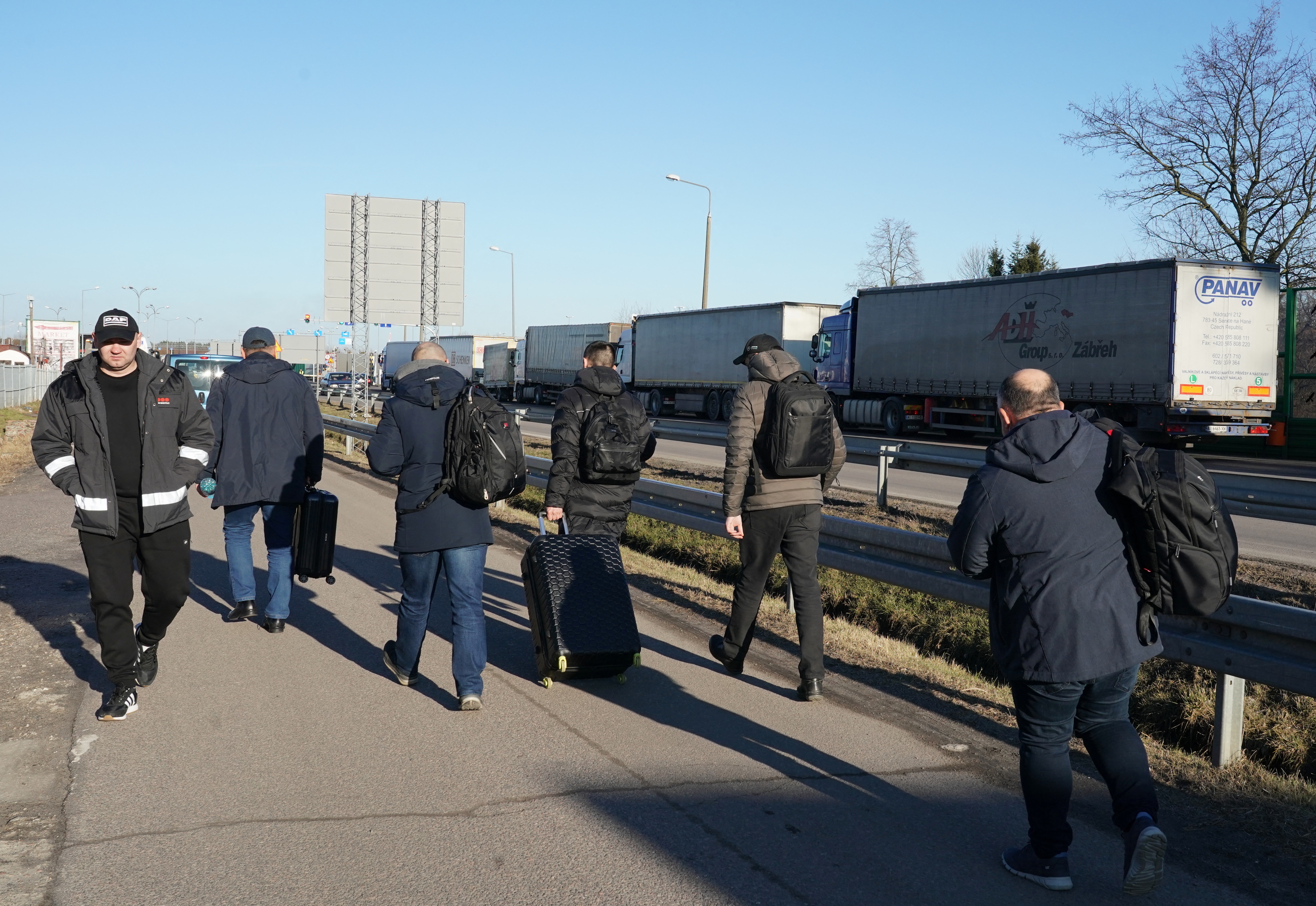 Ukrainian men make their way back to their homes at the Dorohusk border crossing between Poland and Ukraine