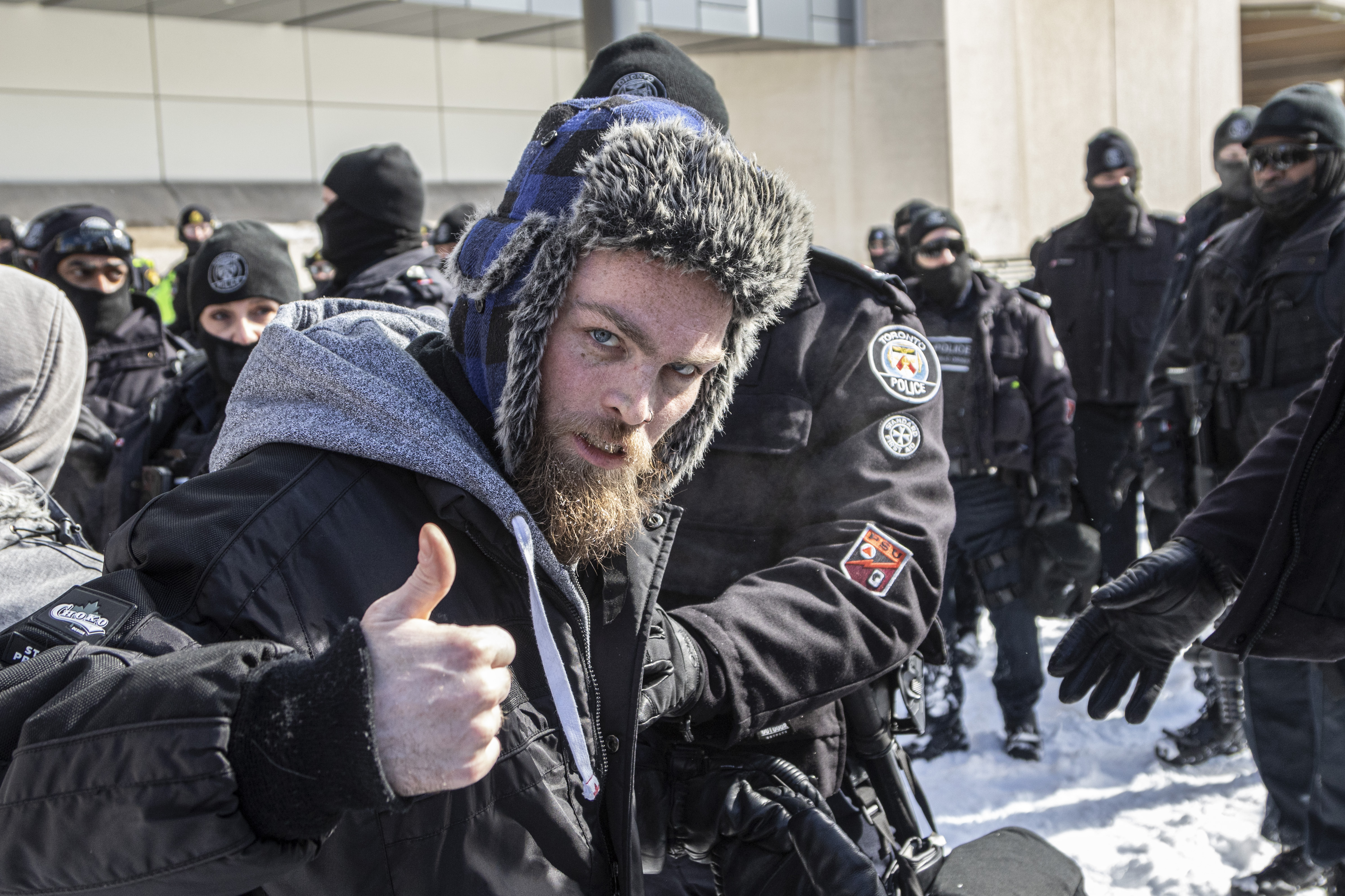 A protester gives a thumbs up as police move in to disperse the demonstration