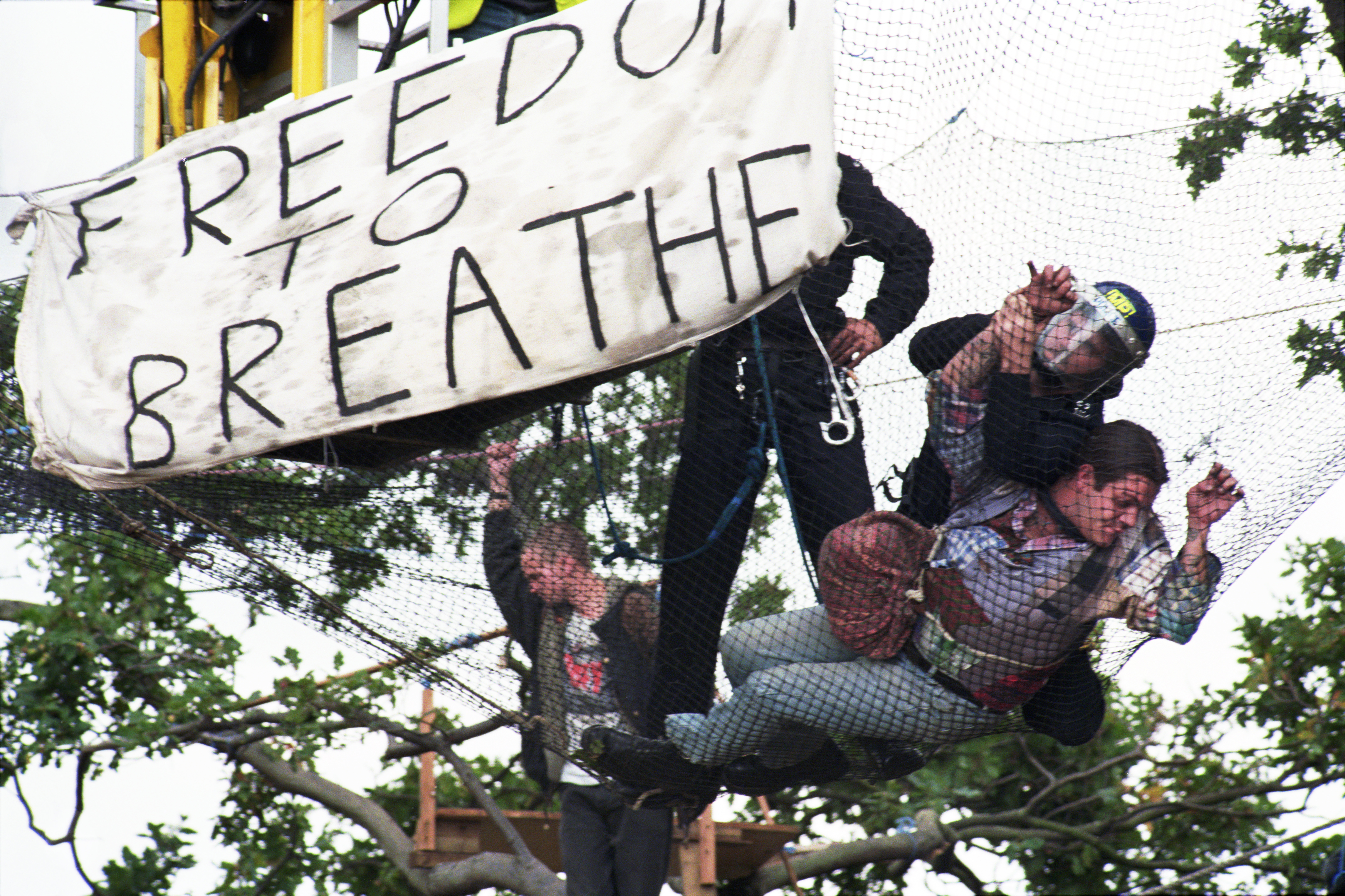 A protestor is tackled in a mesh net in East London