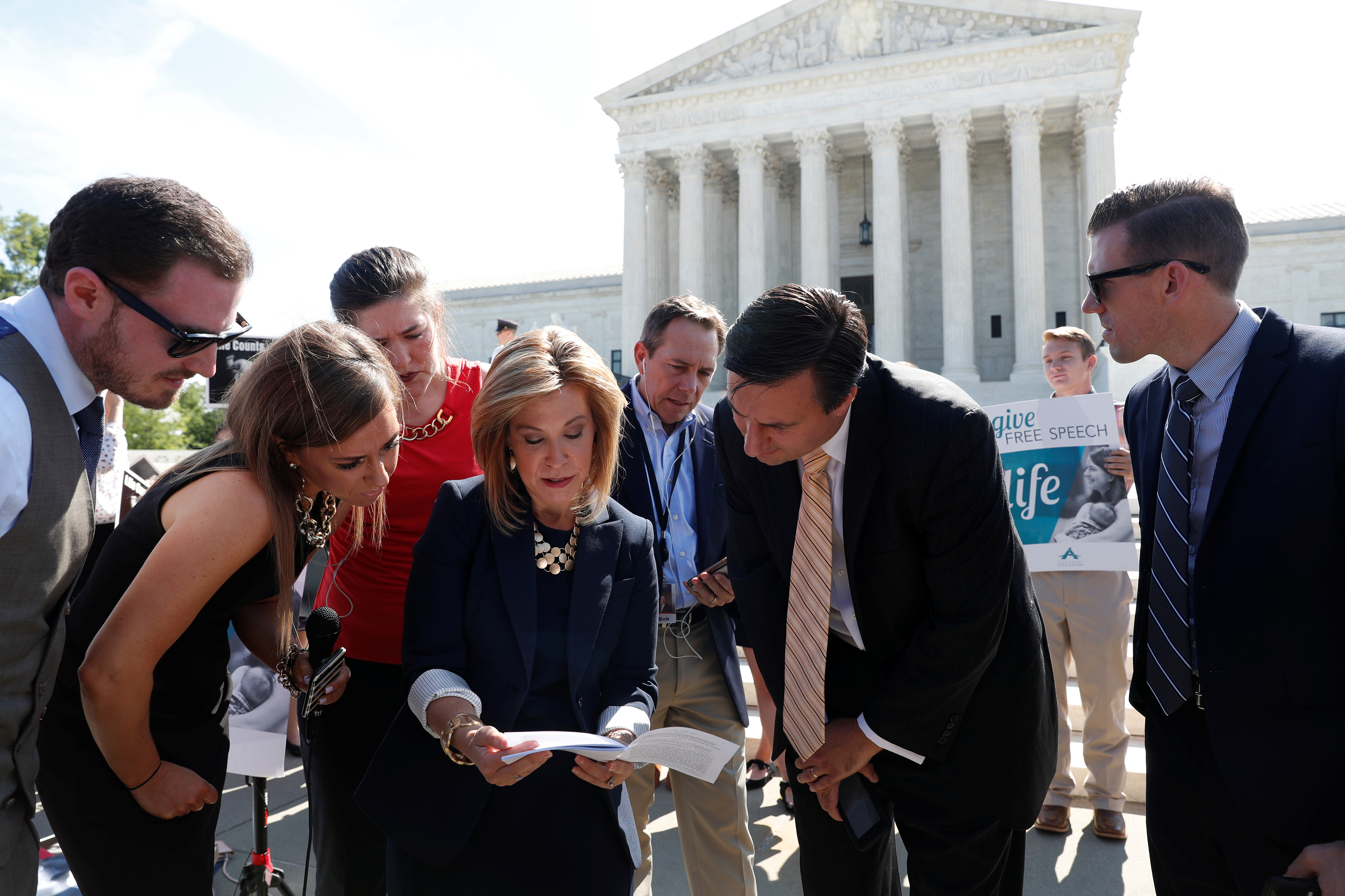 Lawyers of Alliance Defending Freedom reading a document