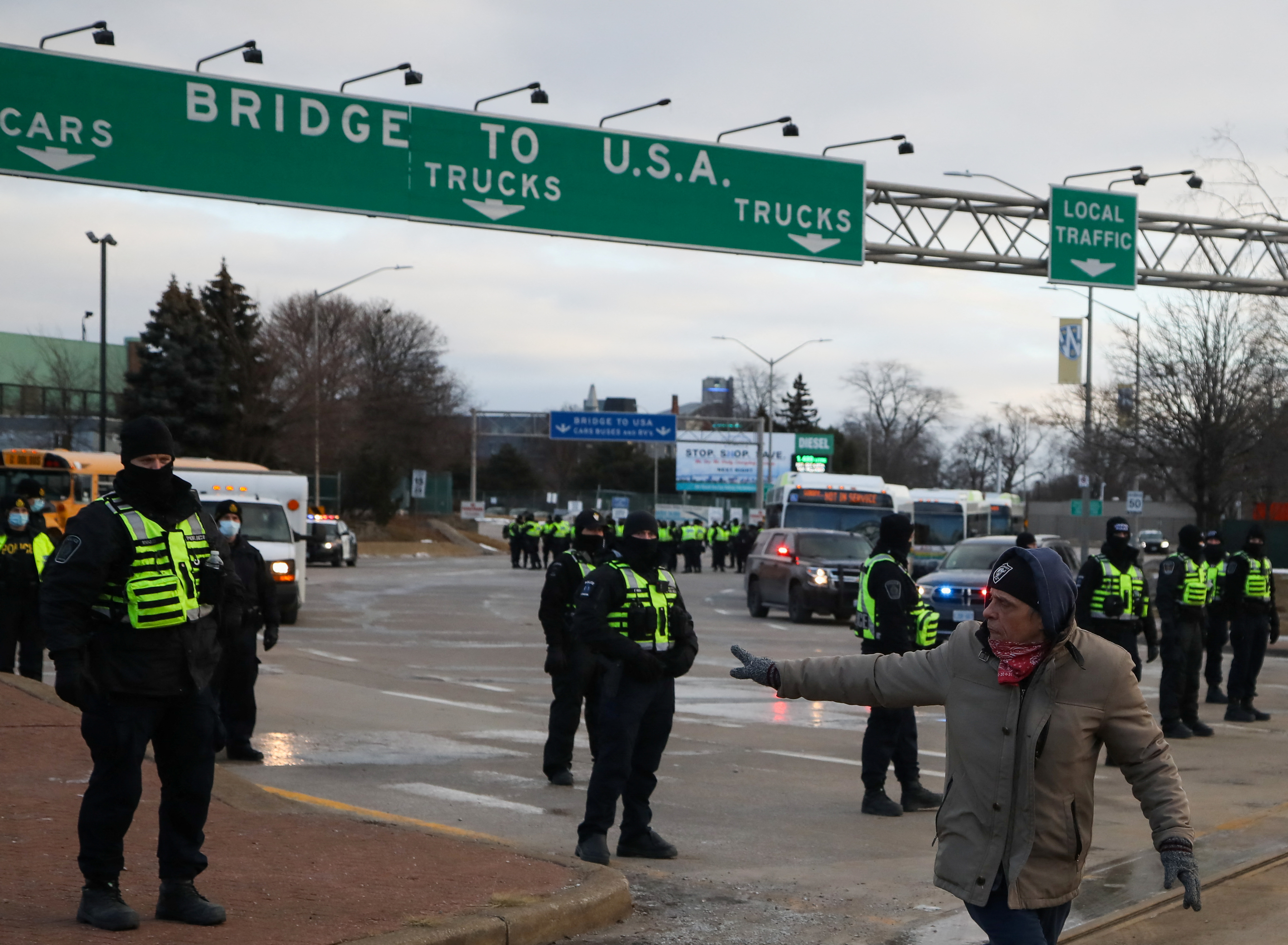 Police officers stand guard on a road leading to the bridge to the US