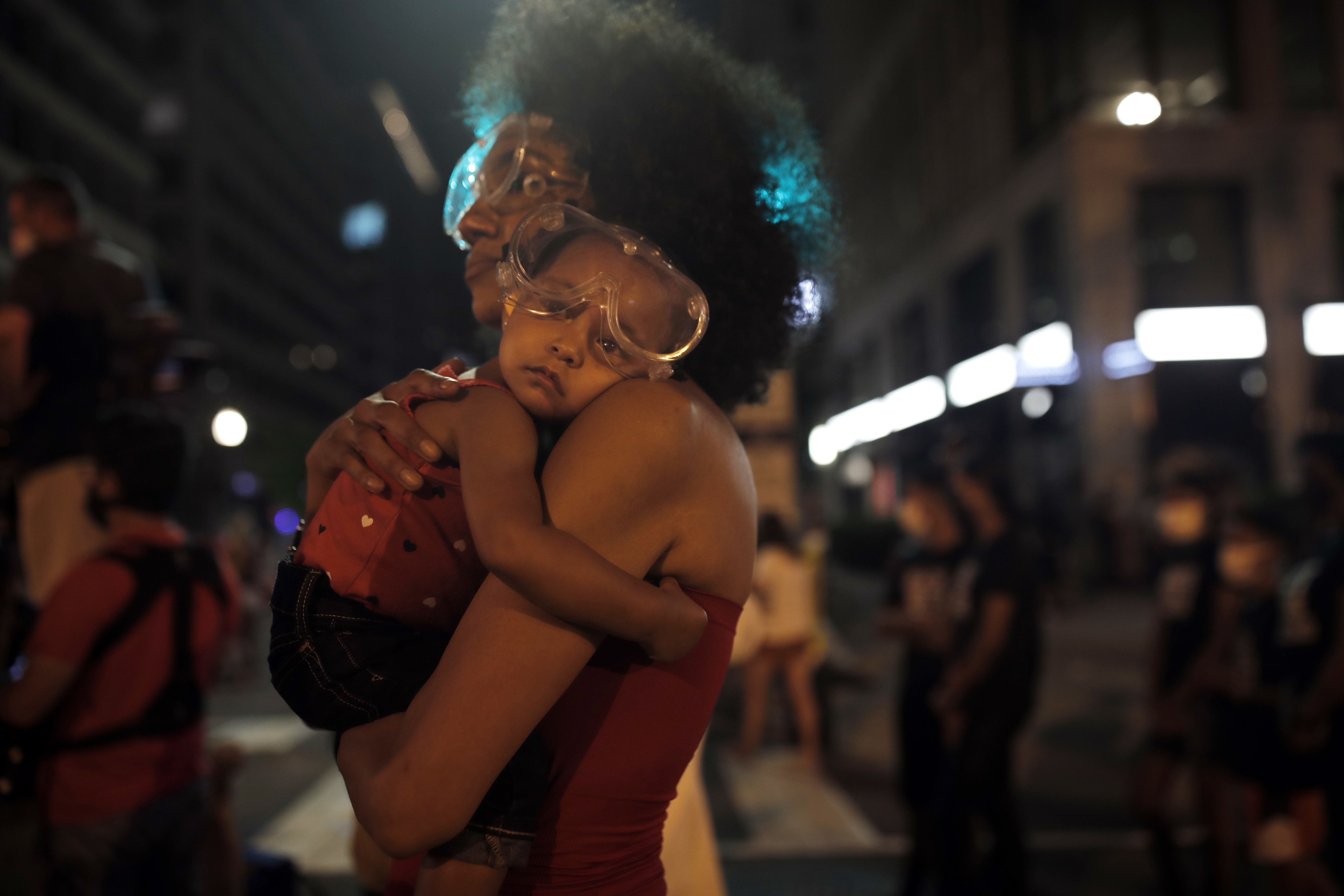 Woman carrying baby during protest