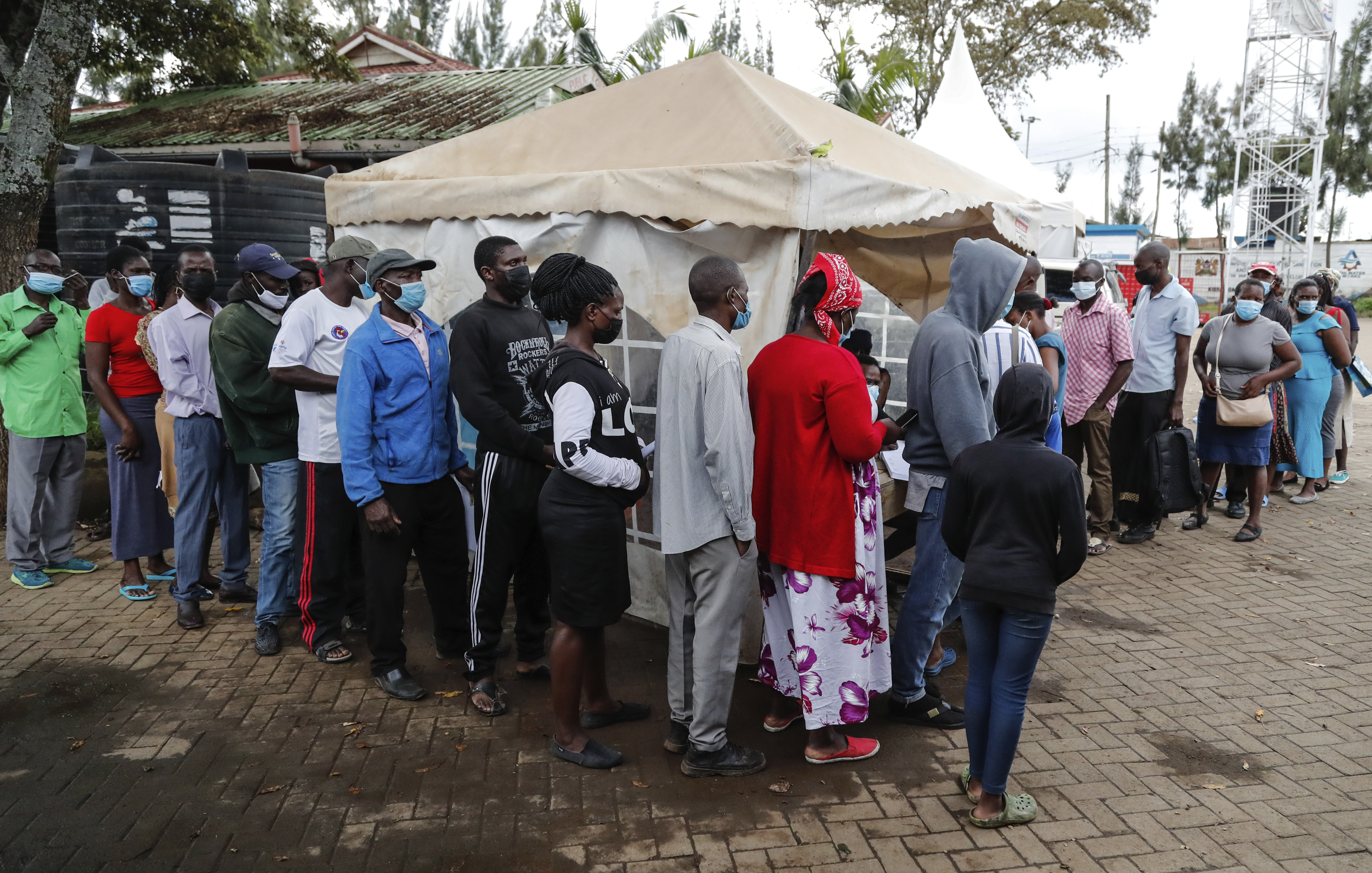 Kenyans queue at vaccination centers at the Kibera informal settlement in Nairobi