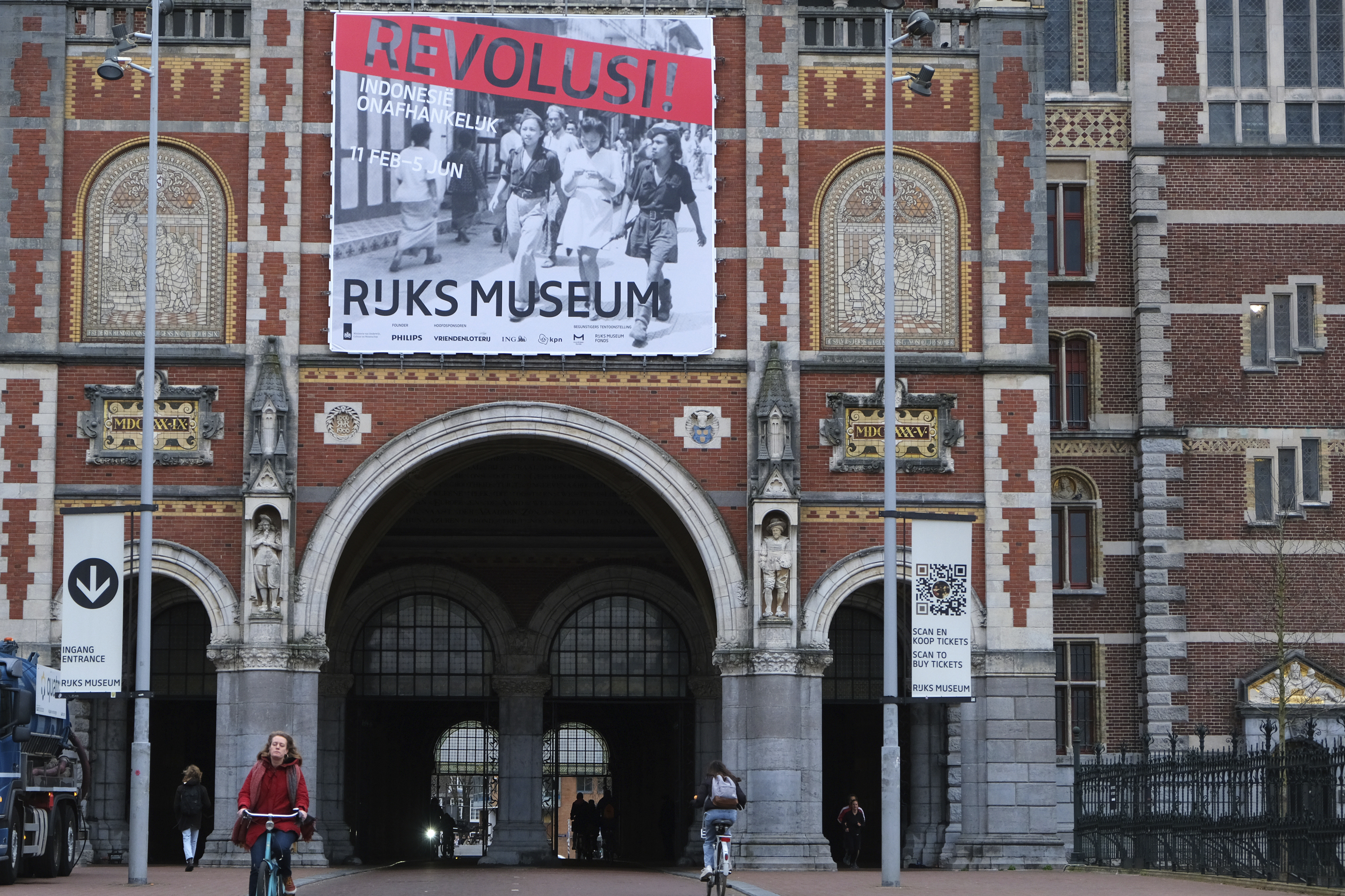 A banner advertising the exhibition on Indonesian independence hangs outside the red brick facade of the Rijksmuseum in Amsterdam