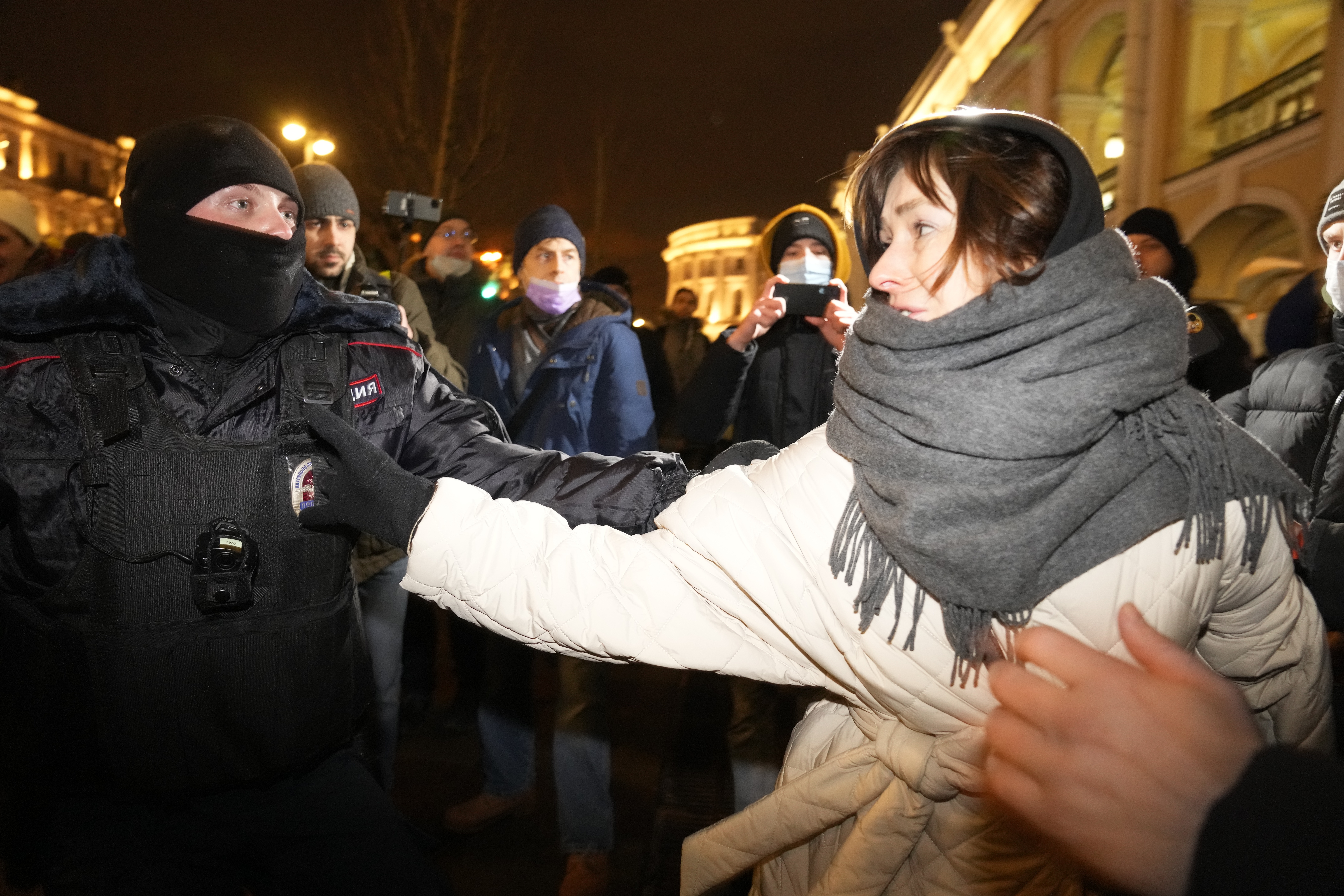 A police officer arrests a woman during a gathering in Saint Petersburg, Russia, Thursday, February 24, 2022, after Russia's attack on Ukraine. Hundreds of people gathered in the center of Moscow on Thursday to protest Russia's attack on Ukraine, and many of the demonstrators were arrested. Similar protests took place in other Russian cities, where activists were also arrested.