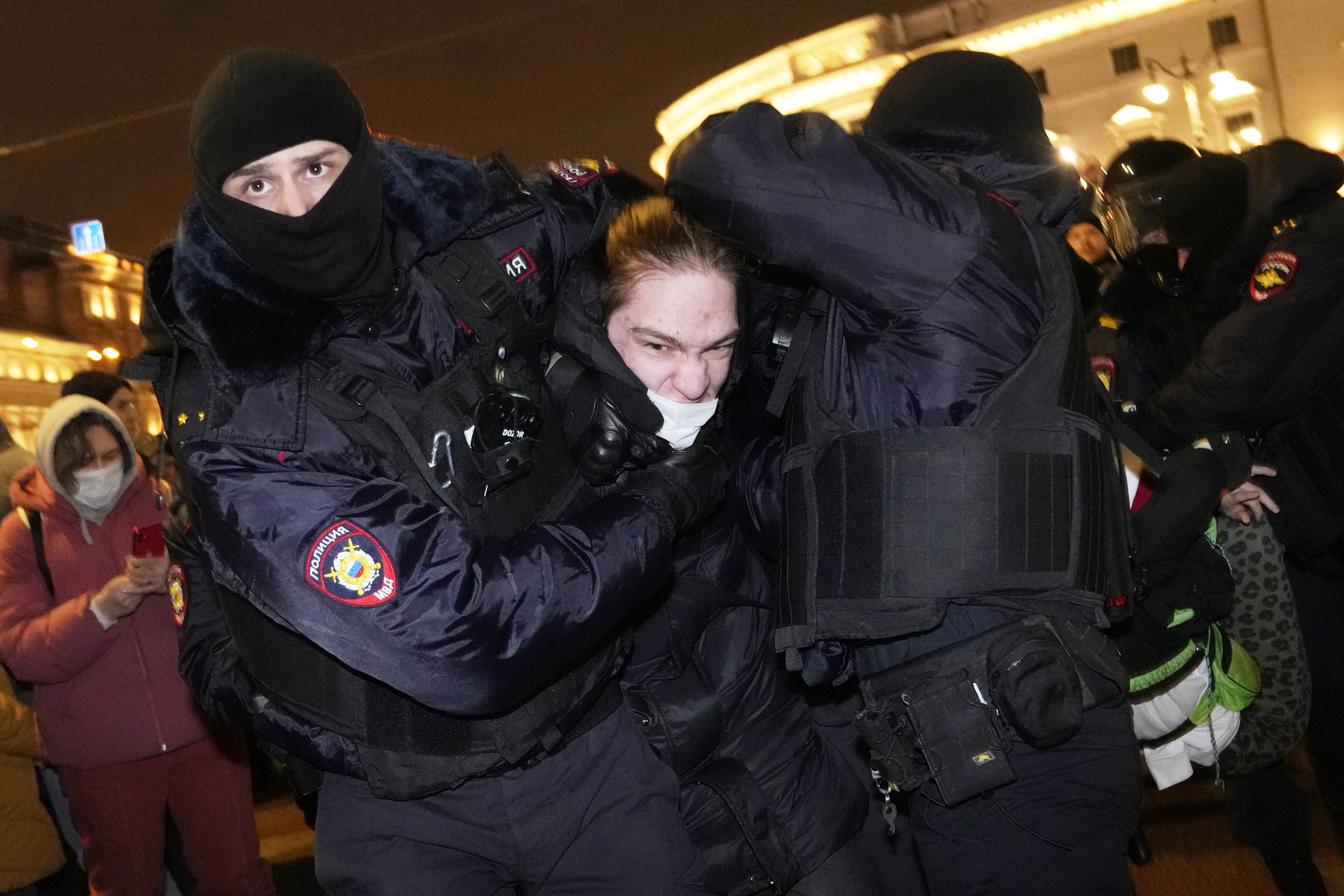 Police officers detain a demonstrator in St. Petersburg