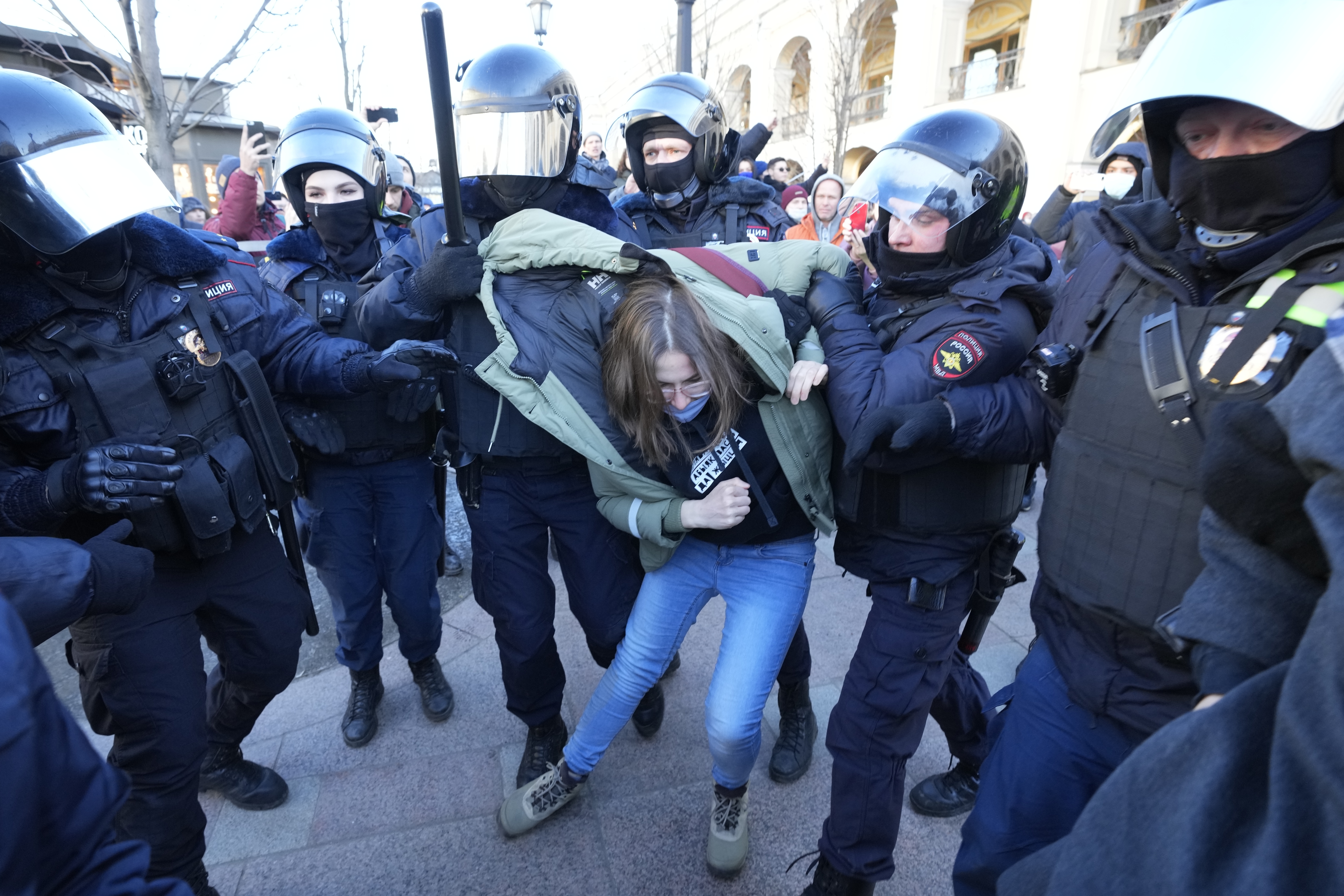 Police detain a demonstrator during an action against Russia's attack on Ukraine in St. Petersburg, Russia