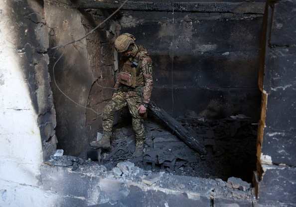 A serviceman of Ukrainian Military Forces inspects a position after a shelling on the front line with Russia.