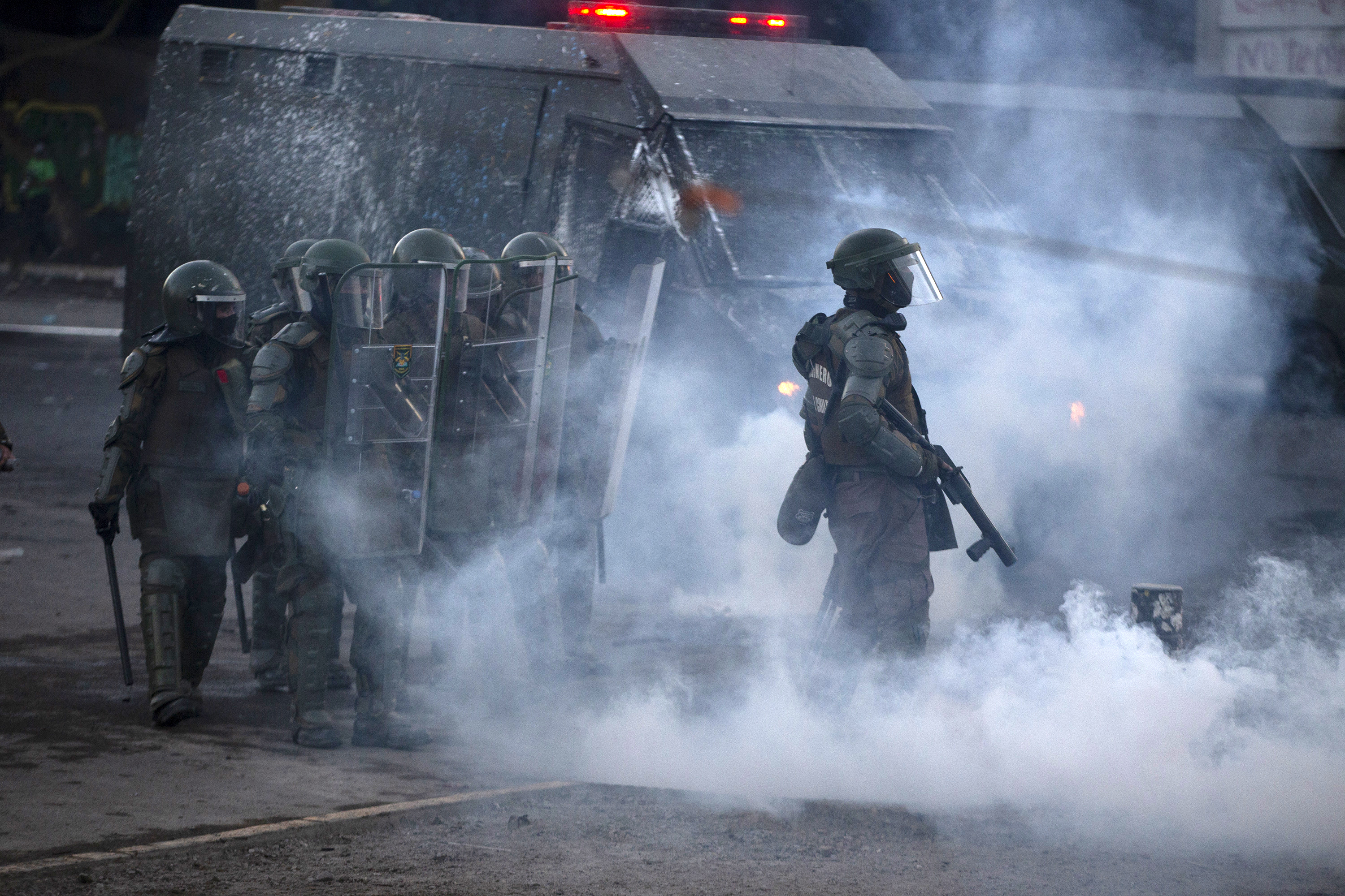 Riot police clash with demonstrators during a protest against Chilean President Sebastian Pinera's government