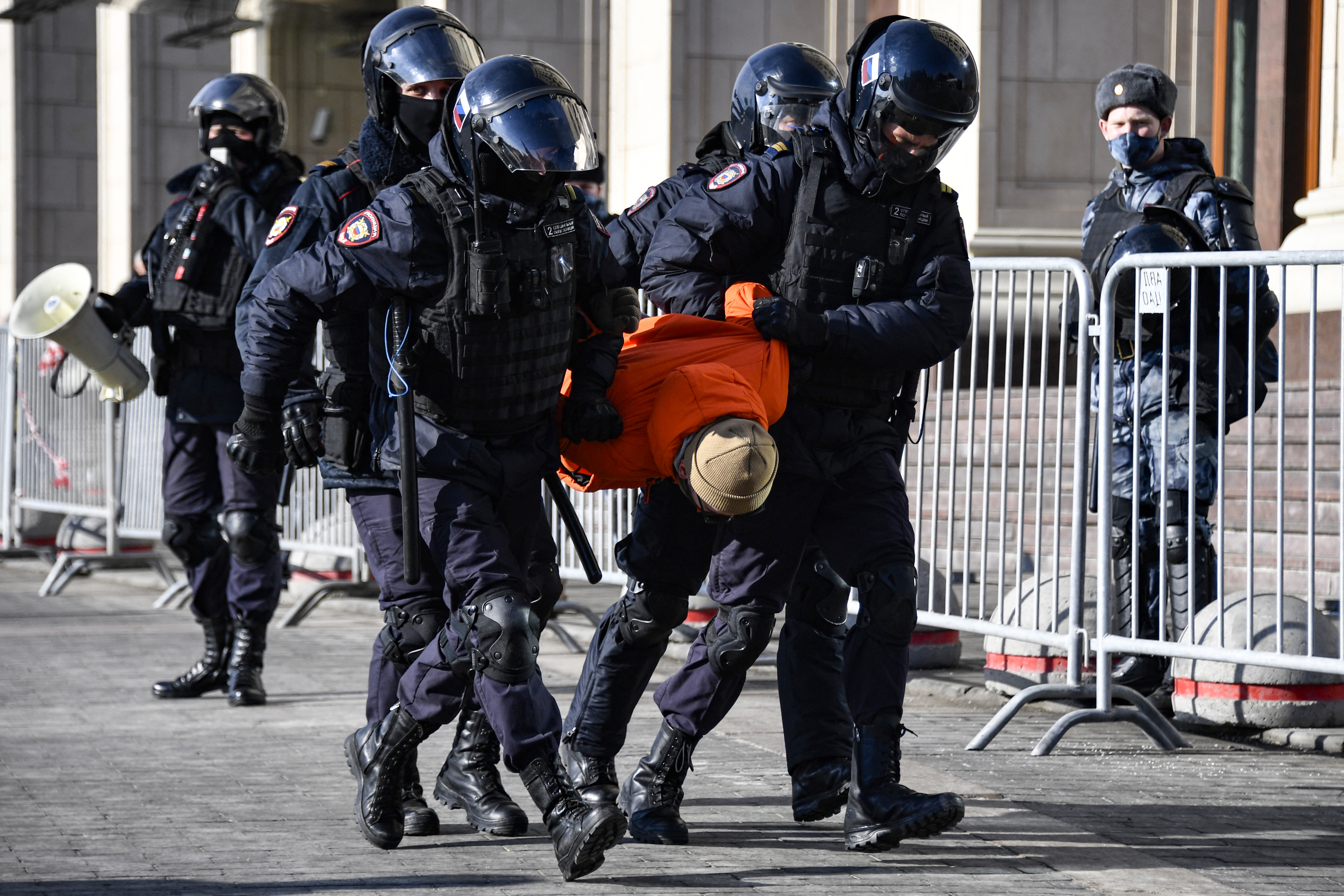 Police officers detain a man during a protest against Russian military action in Ukraine, in Manezhnaya Square in central Moscow