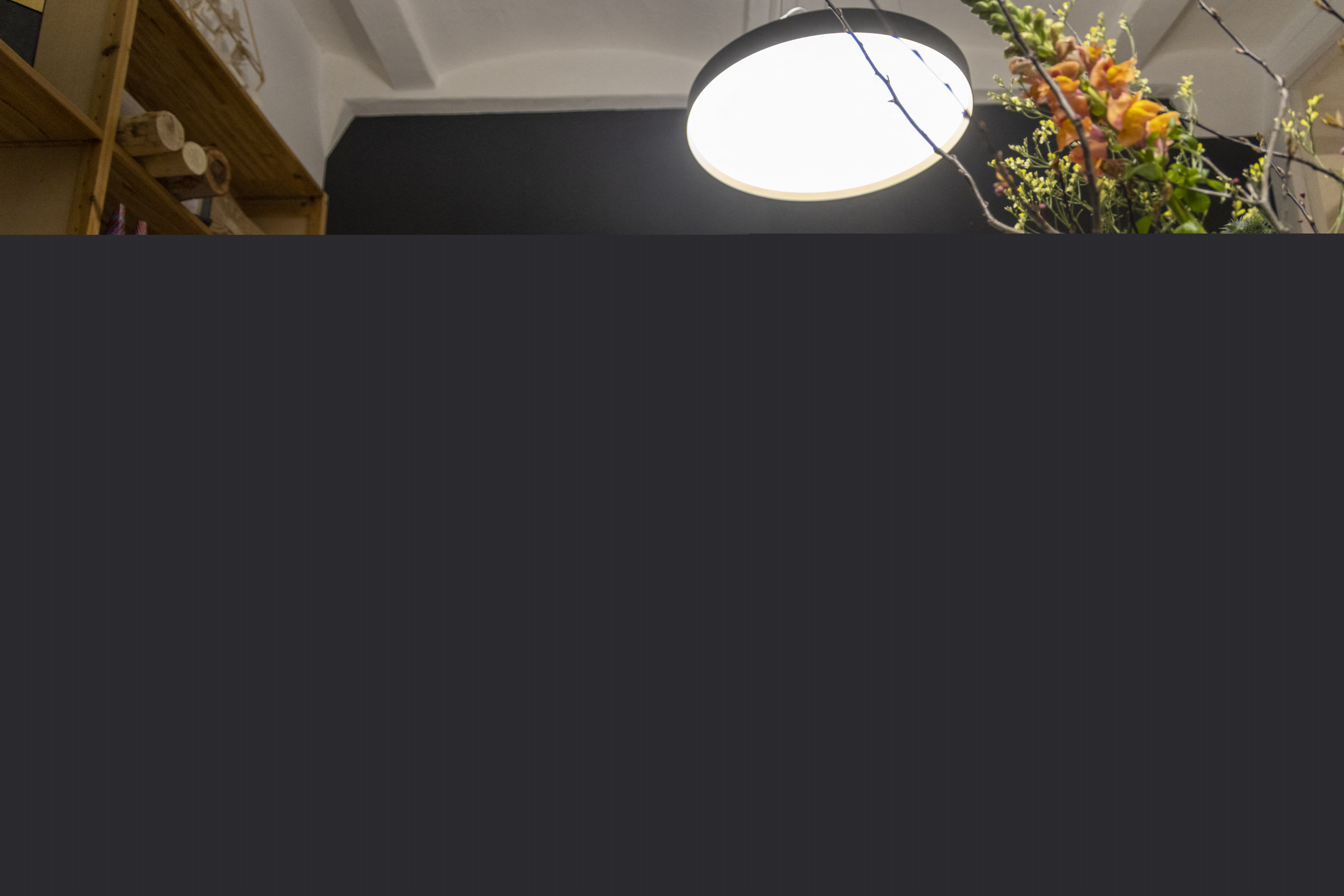 Diebedo Francis Kere, in a royal blue shirt, sits at his desk in his Berlin office