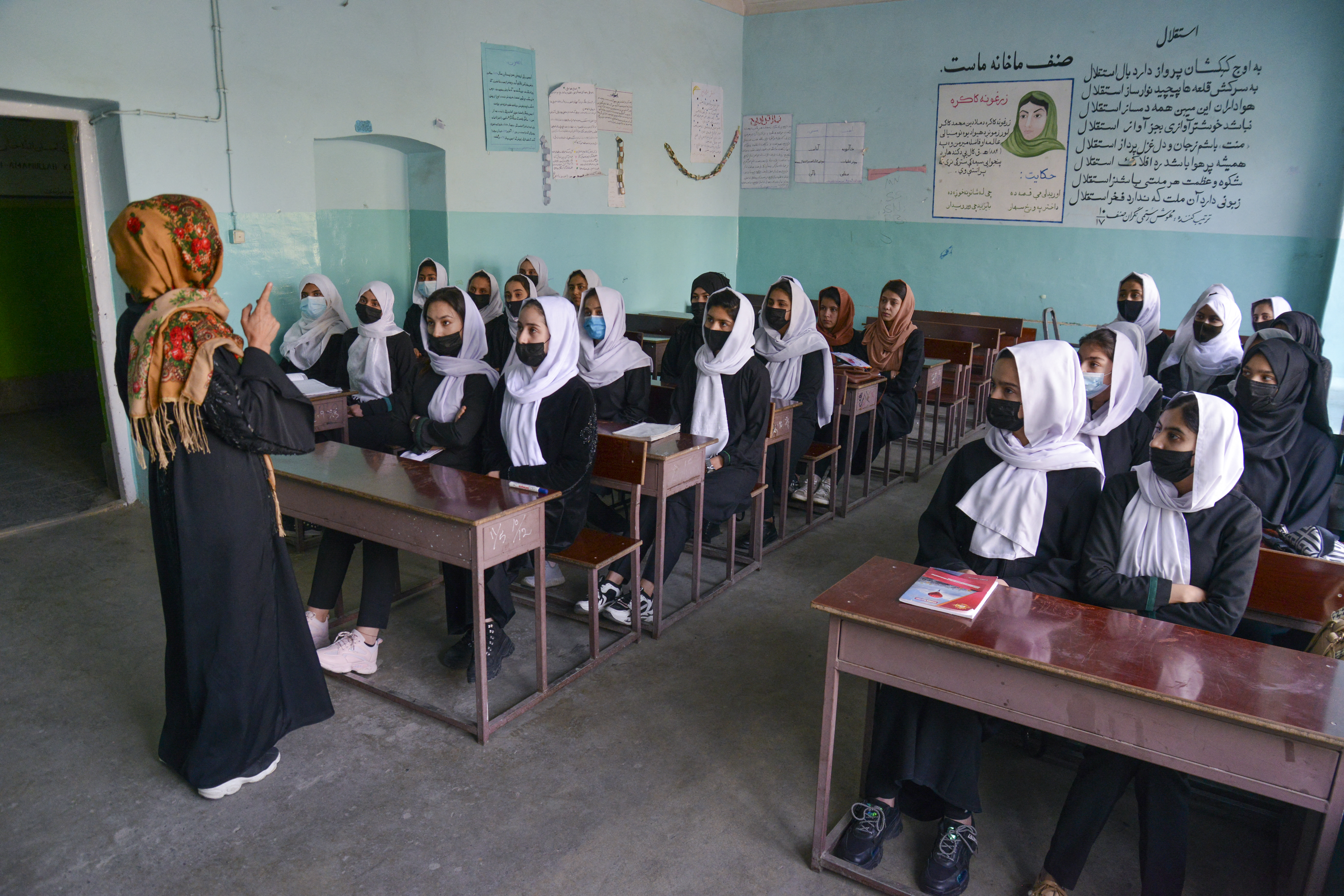 Girls attend a class after their school reopening in Kabul