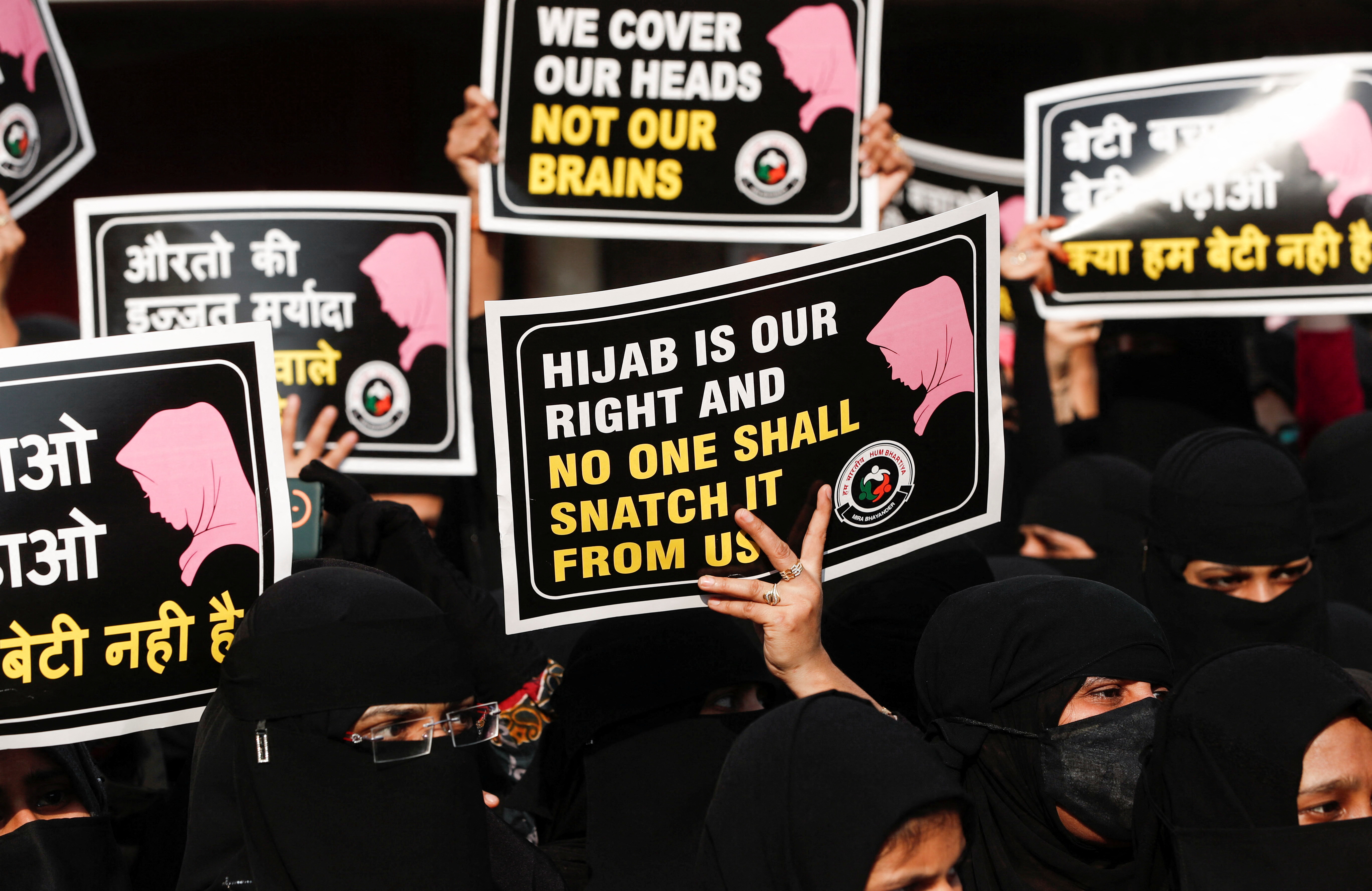 Indian women hold placards during a protest, against the recent hijab ban.