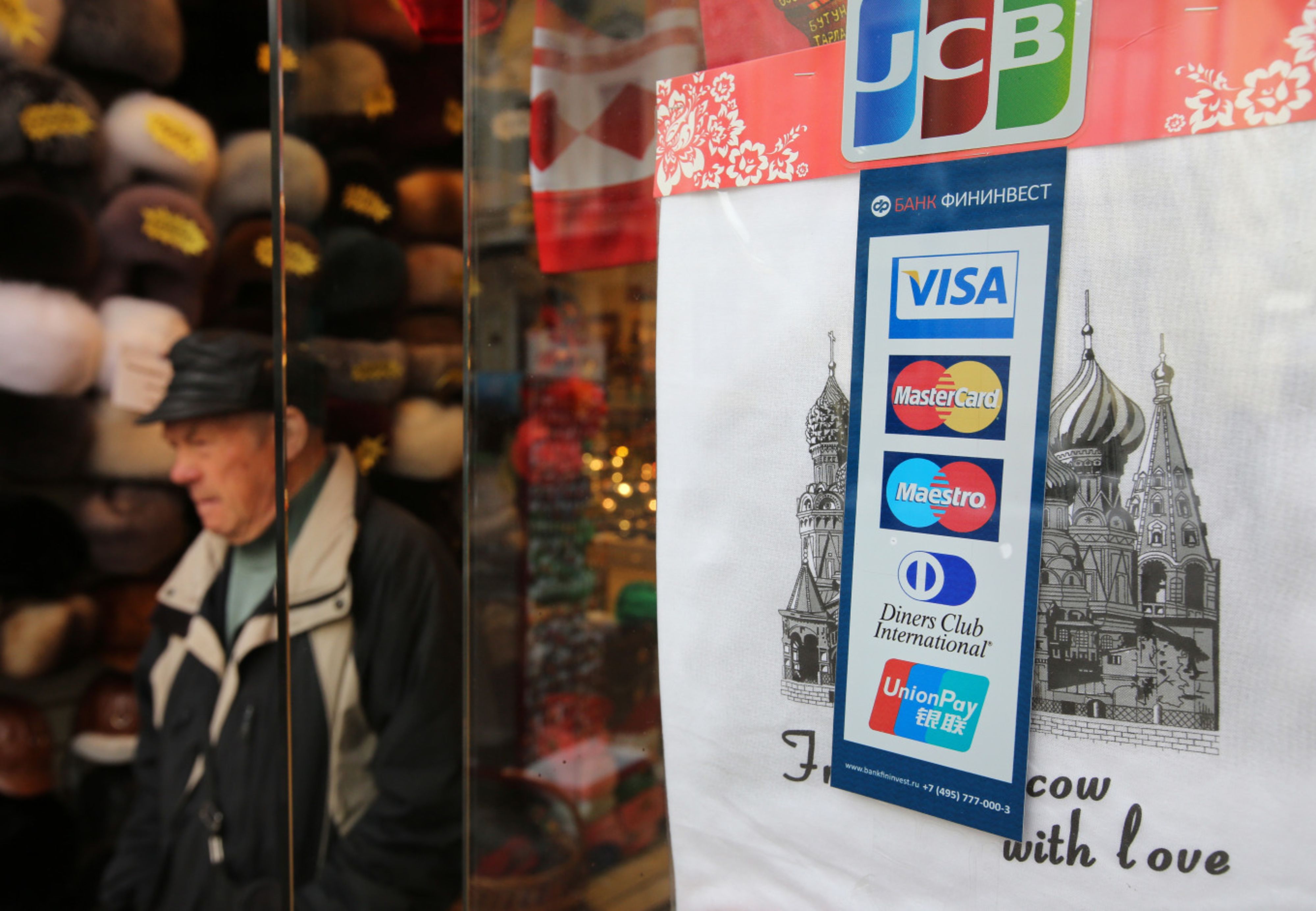 Logos for Visa Inc., Mastercard Inc., Diners Club International Ltd. and China UnionPay Data Co. payment services sit in the window of a souvenir store in Moscow, Russia
