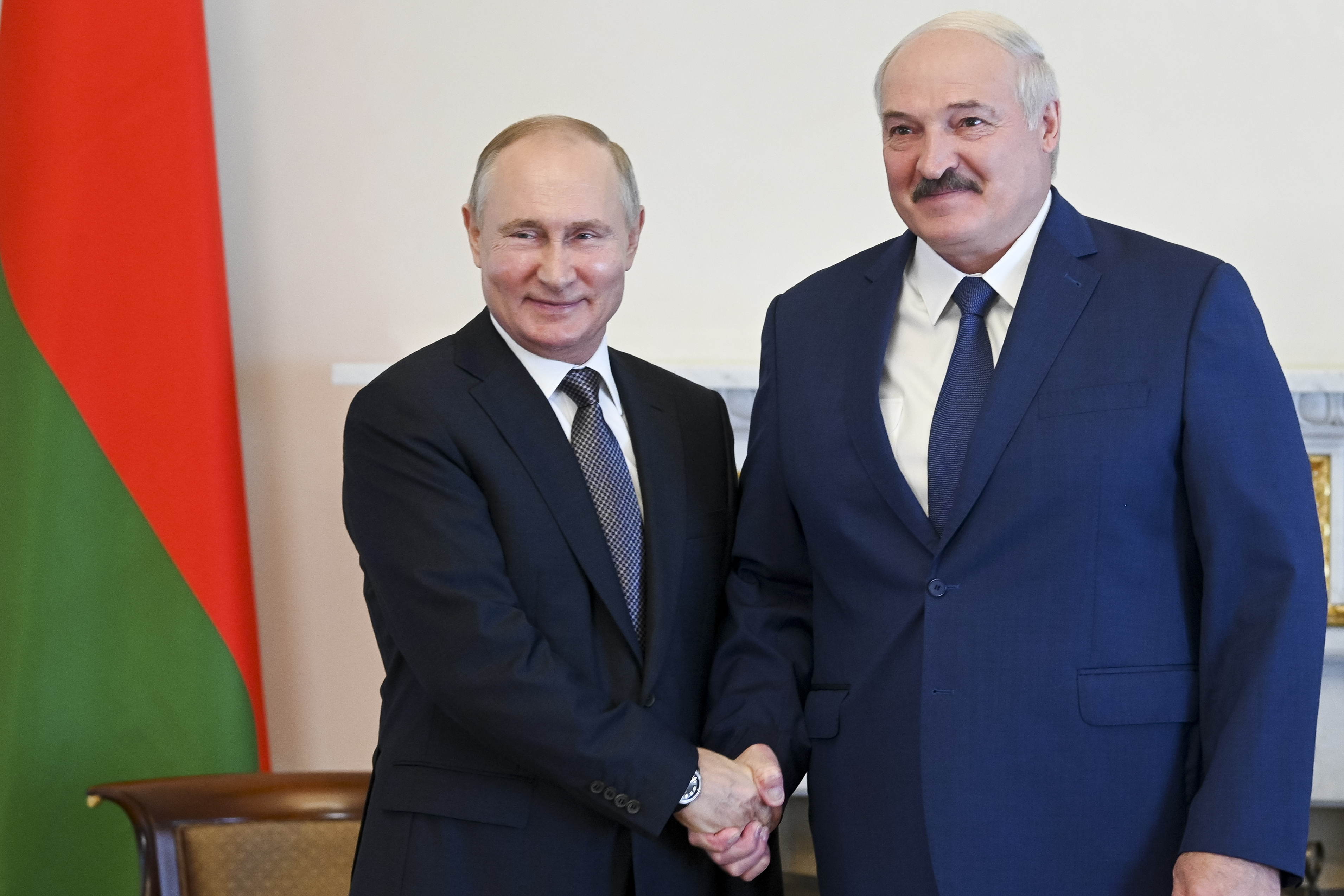 A photo of Russian President Vladimir Putin and Belarusian President Alexander Lukashenko shaking hands.