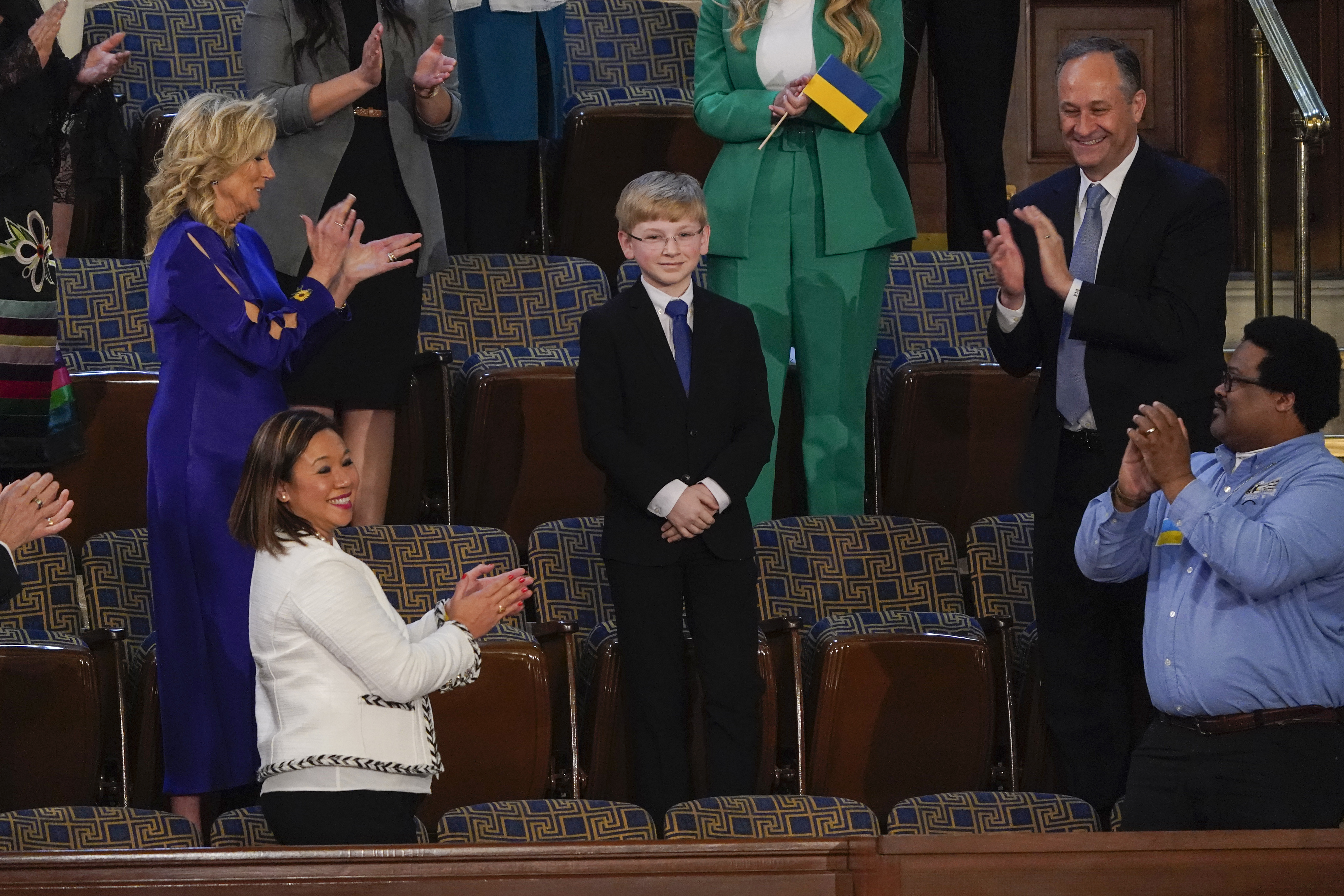 Joshua Davis of Midlothian, Va., center, stands as President Joe Biden acknowledges him during the first State of the Union address