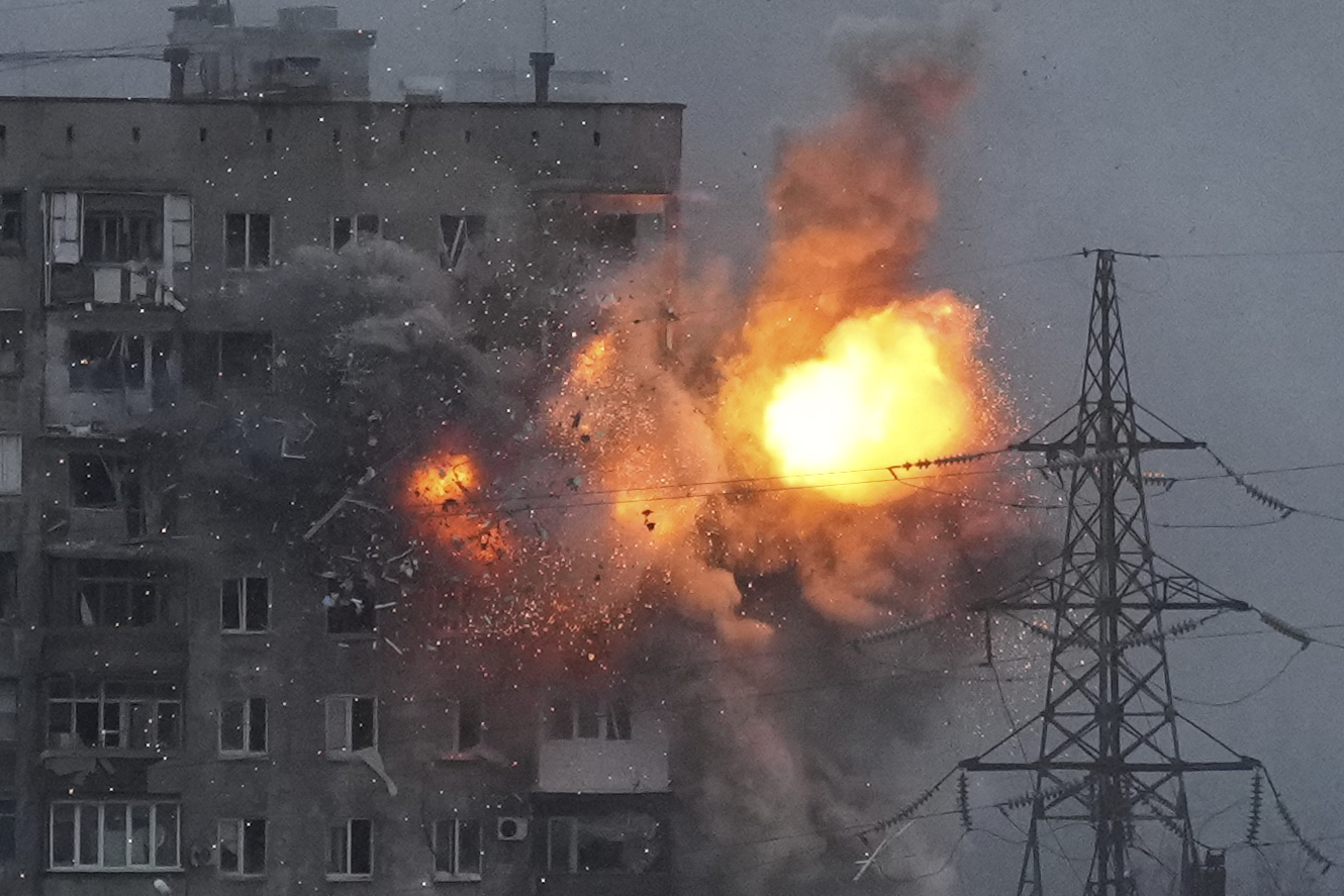 An explosion in an apartment building that came under fire from a Russian army tank in Mariupol, Ukraine,