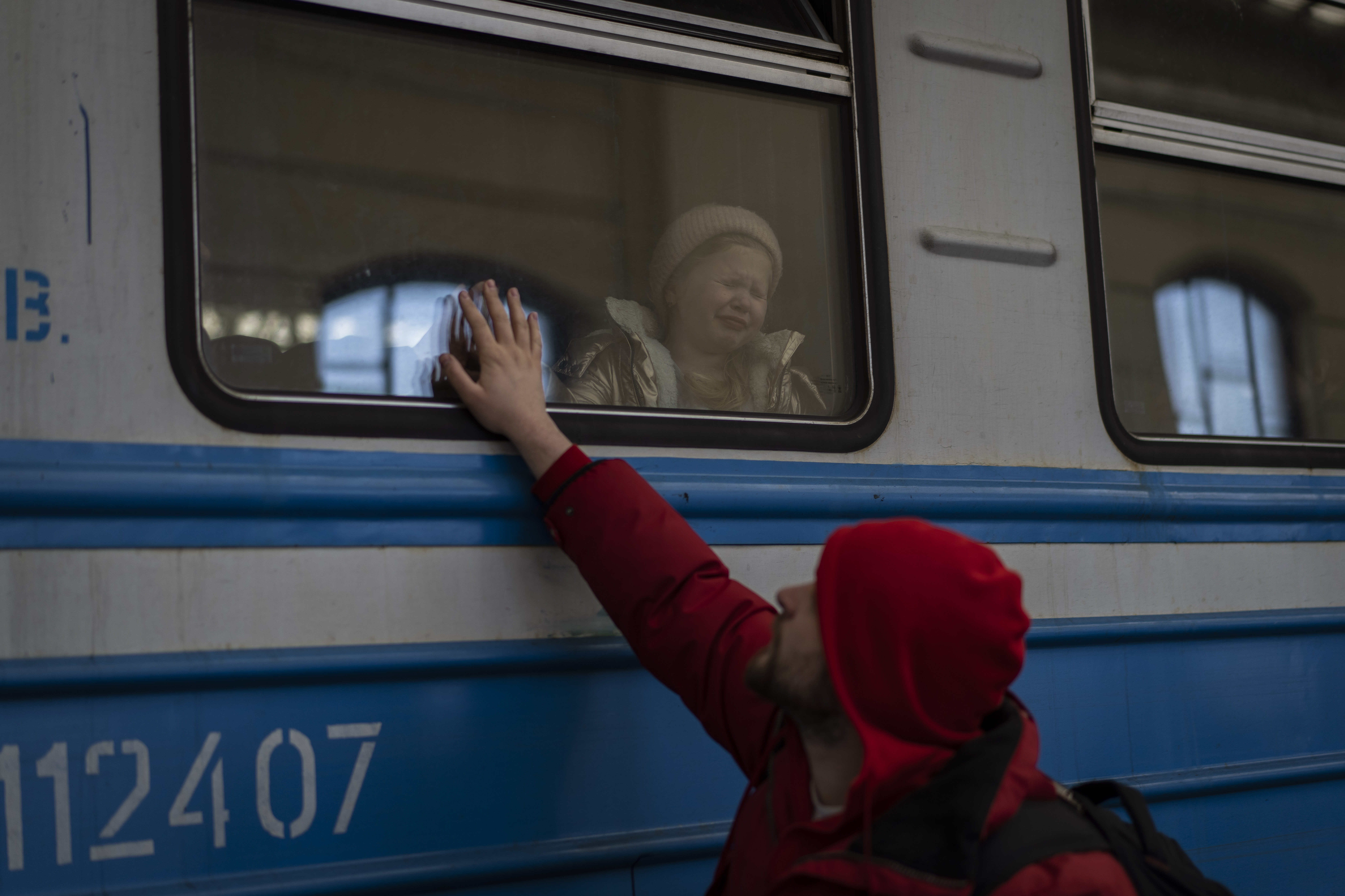 Displaced Ukrainians on a Poland-bound train bid farewell in Lviv