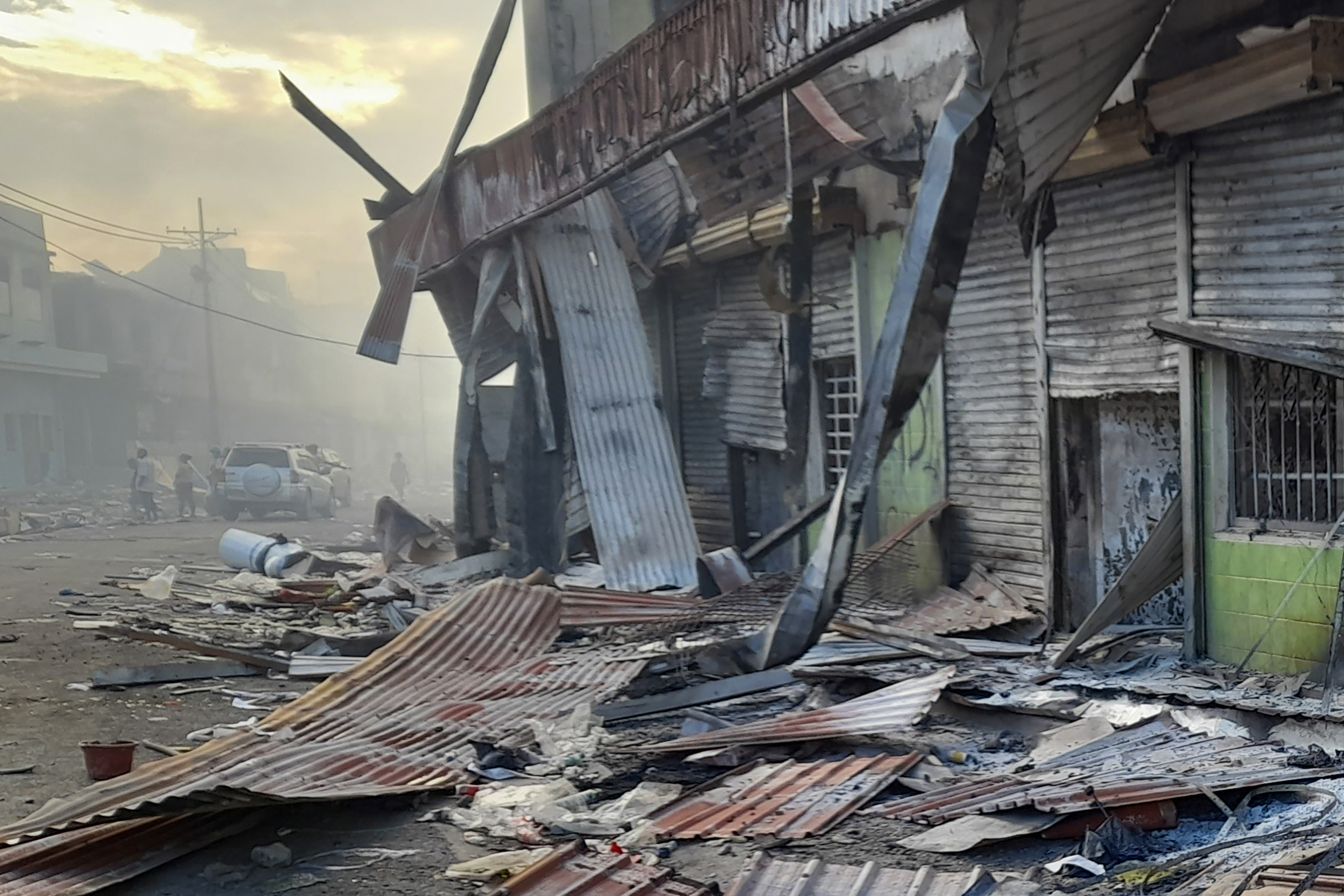 burned out buildings and debris on the streets of Honiara's Chinatown after three days of rioting in November