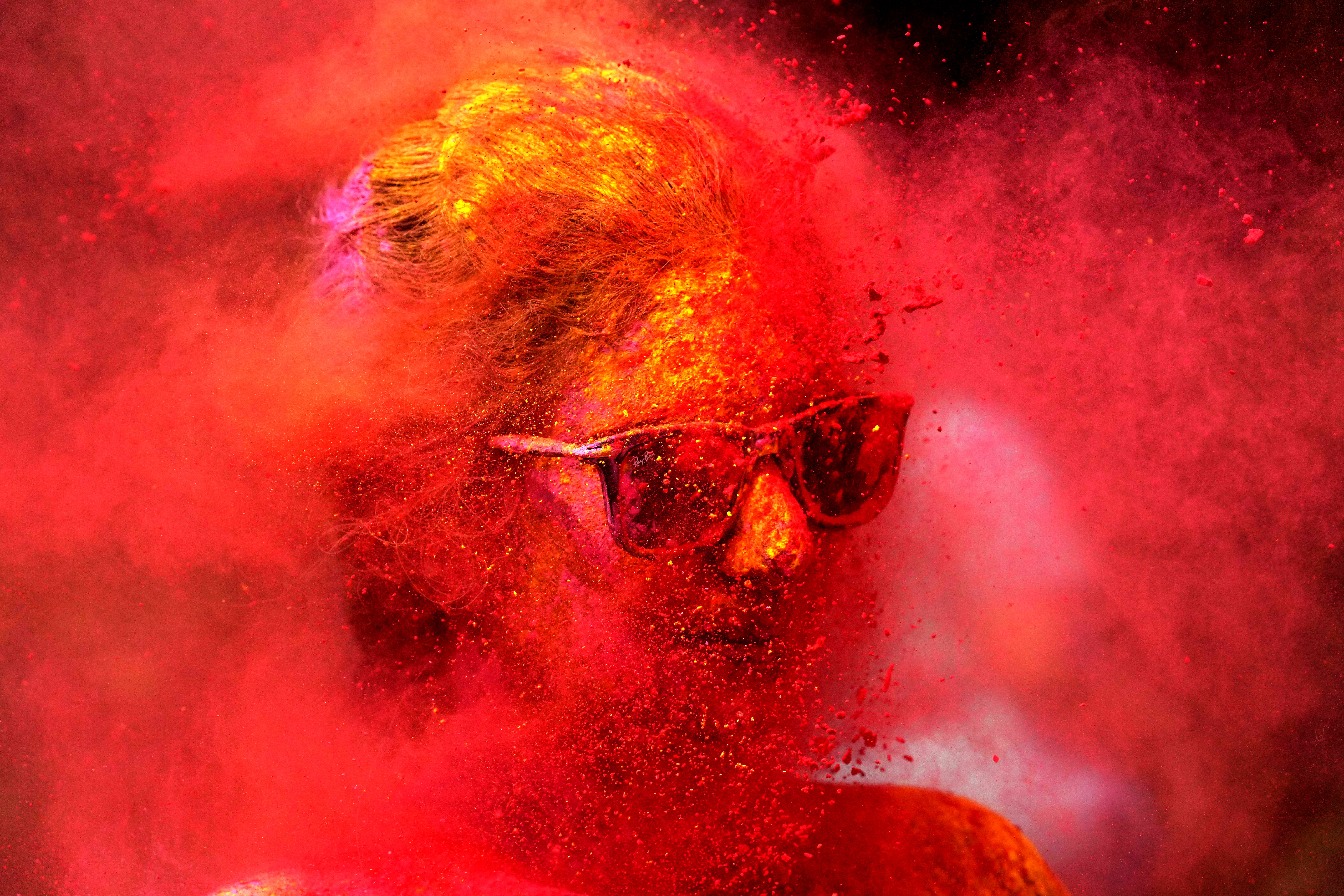 A woman smeared with colors play Holi, the Hindu festival of colors, in Mumbai, India