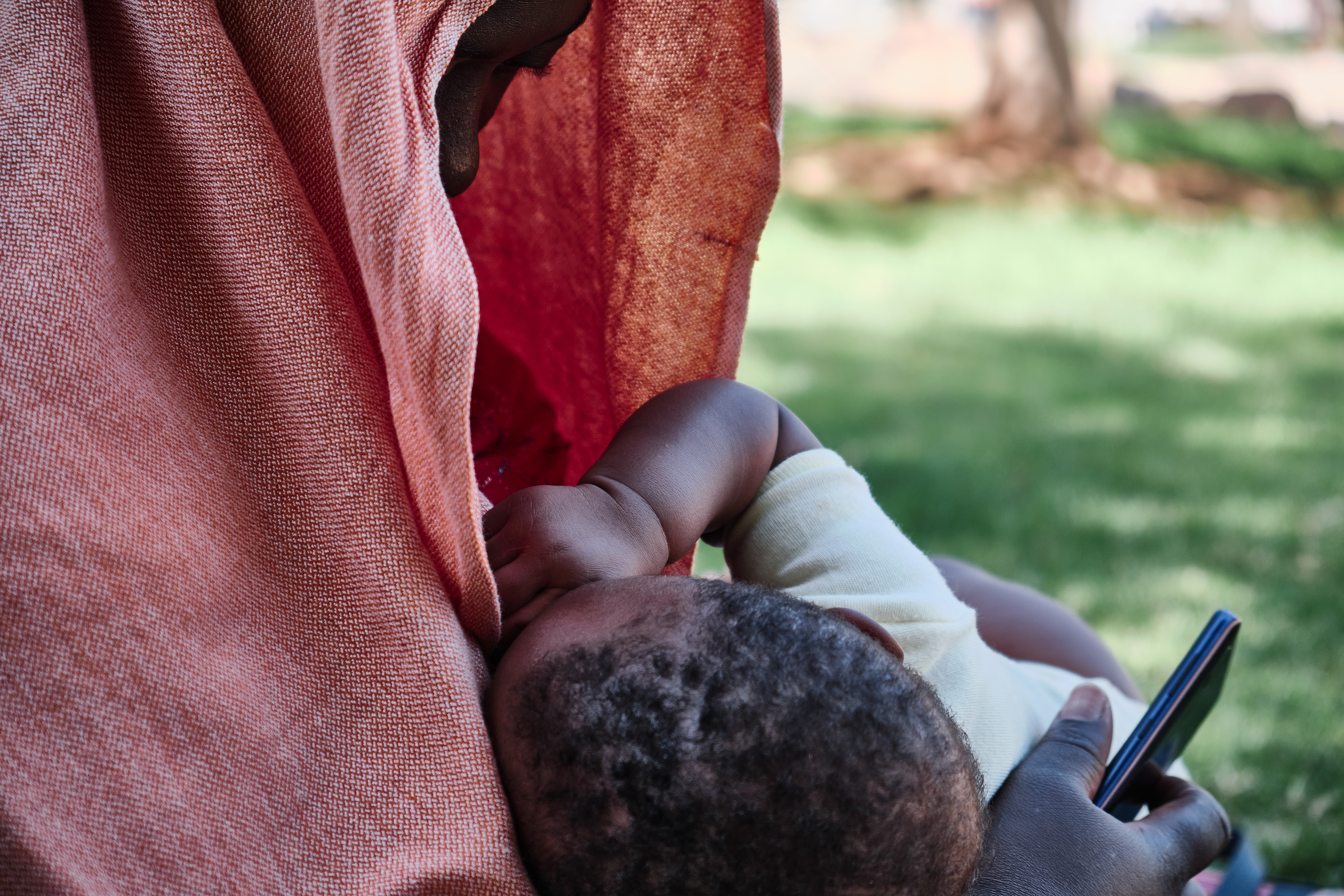 A photo of a woman feeding her baby.