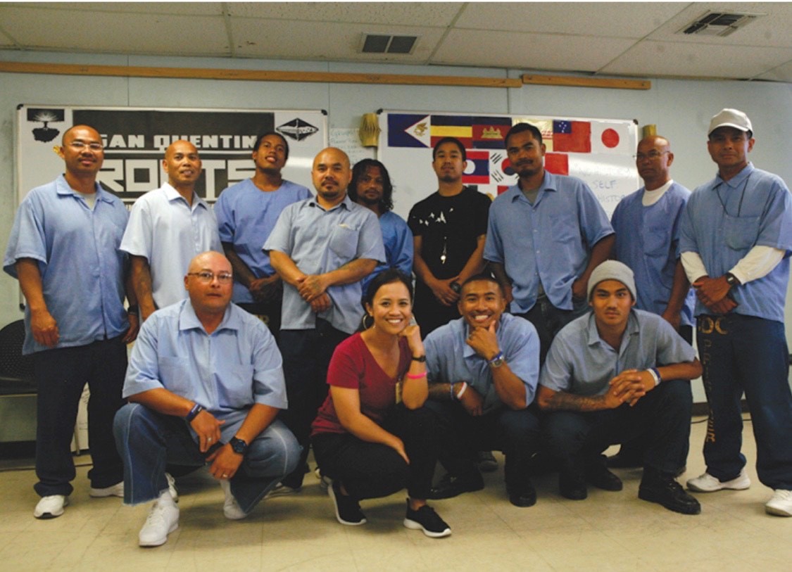 A photo of a group of people including Ny Nourn, APSC volunteer members and incarcerated graduated from San Quentin ROOTS Program graduation in 2019.
