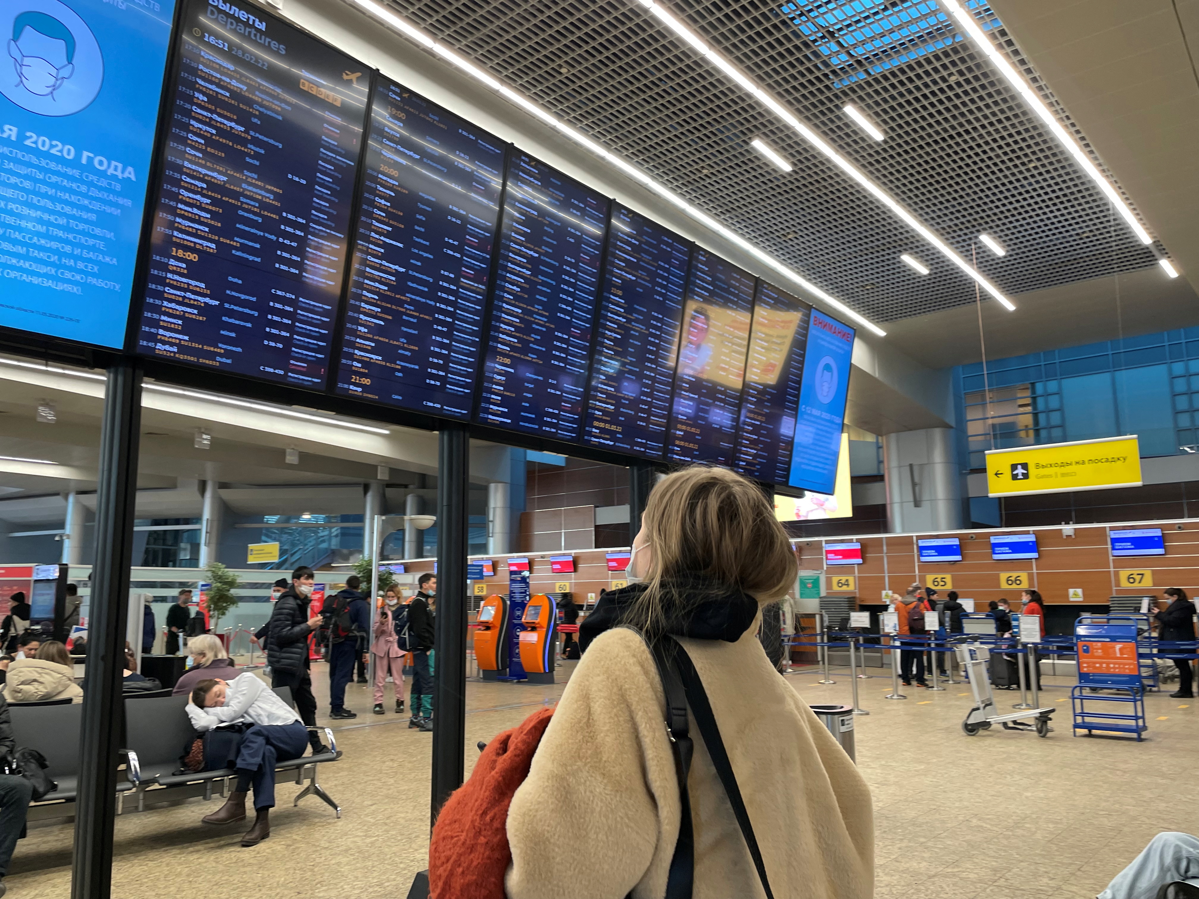A passenger looks at a departures board