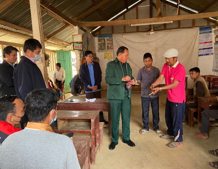 Farmers and officials at a meeting over rat problems in Laos