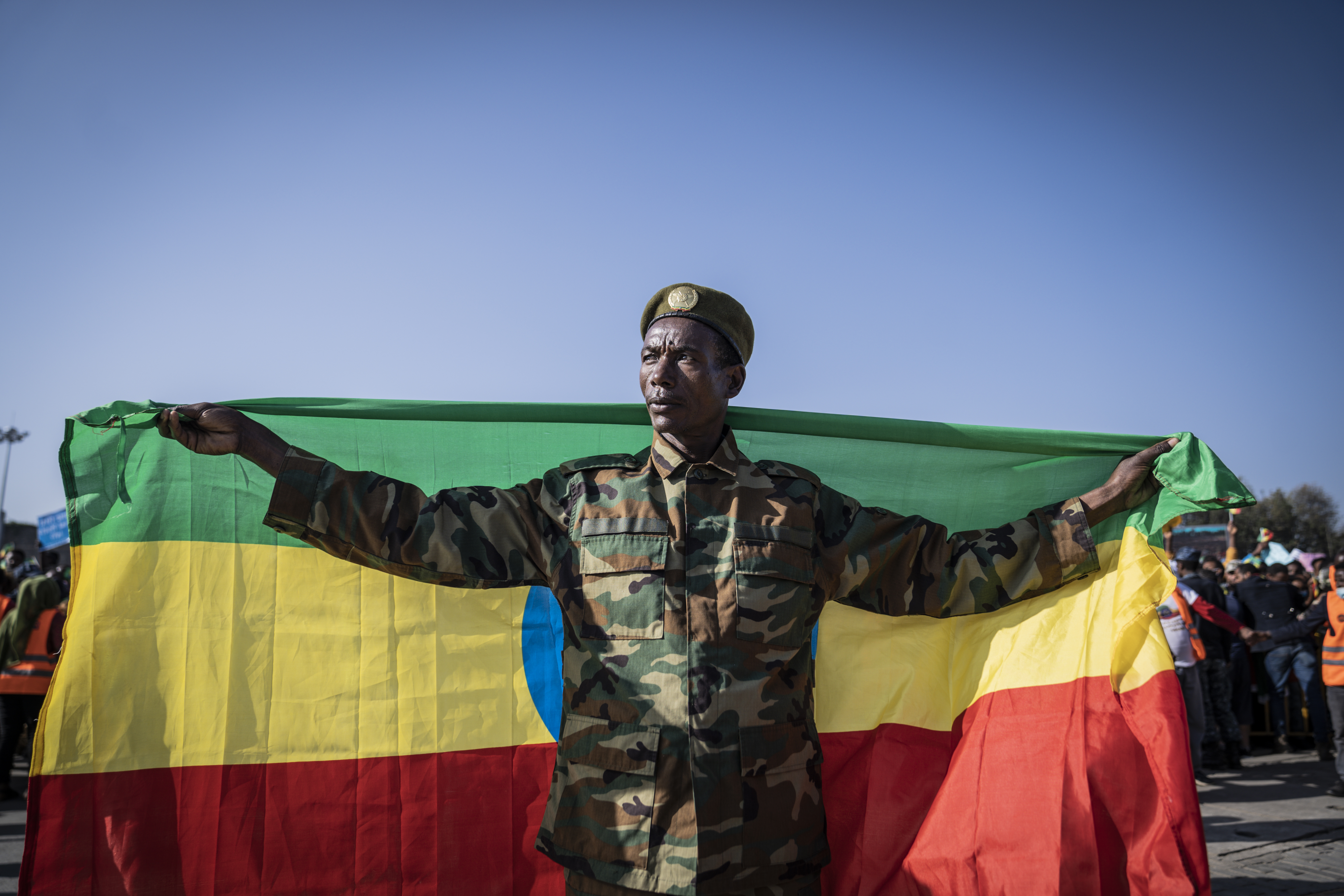 An Ethiopian war veteran is seen at a rally holding the national flag