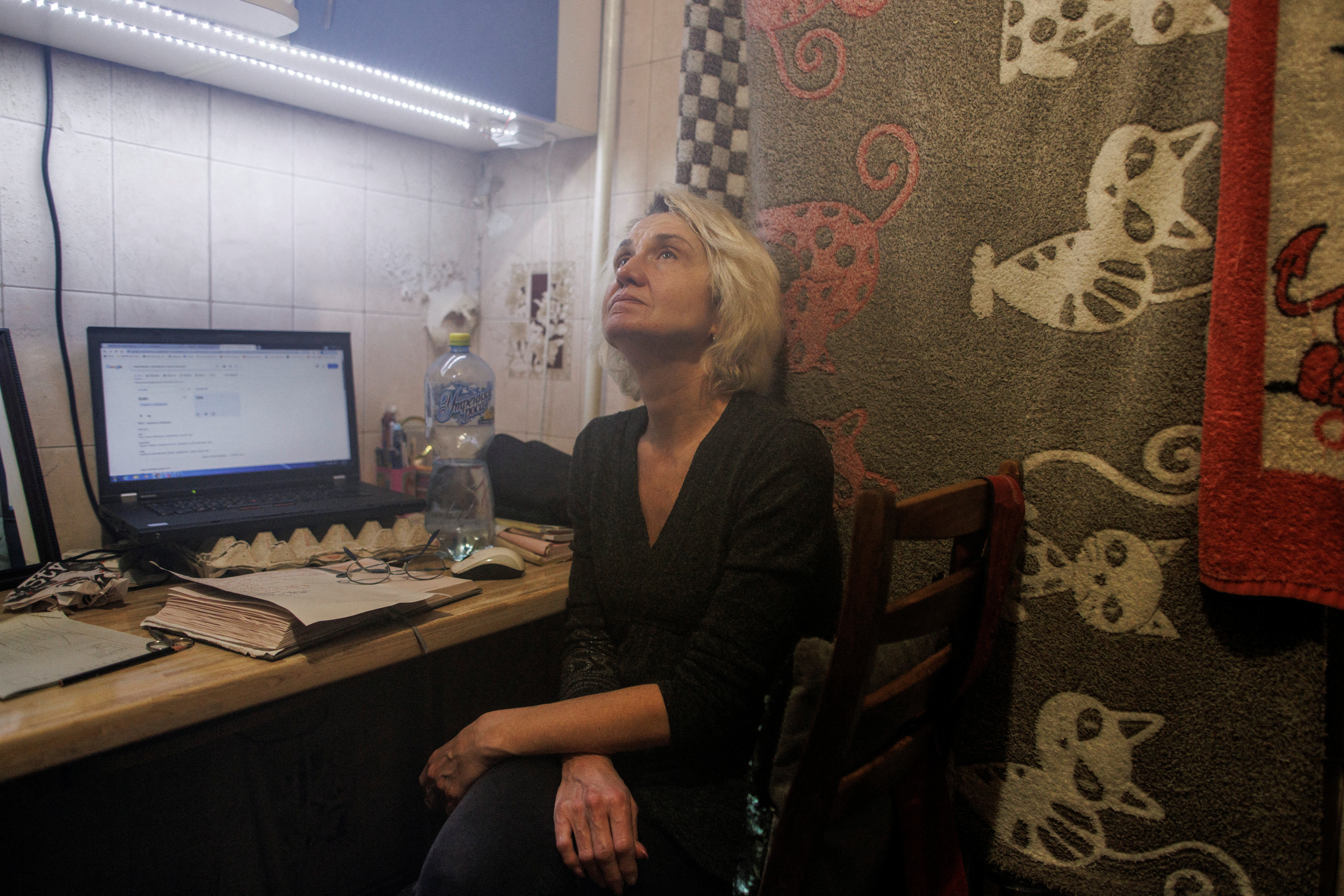 Yana Bachek sits in her family's apartment