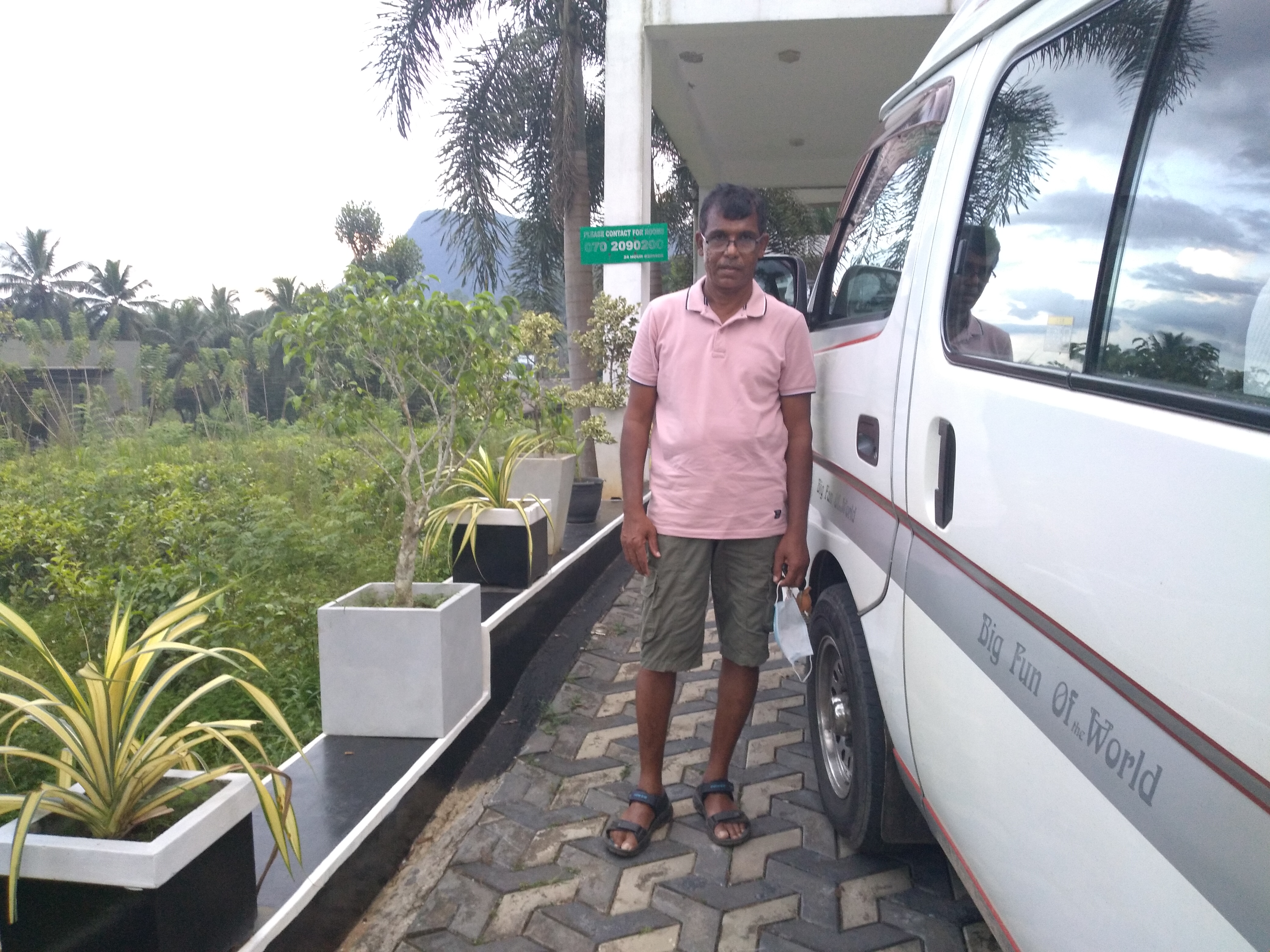 A man stands in front of a taxi