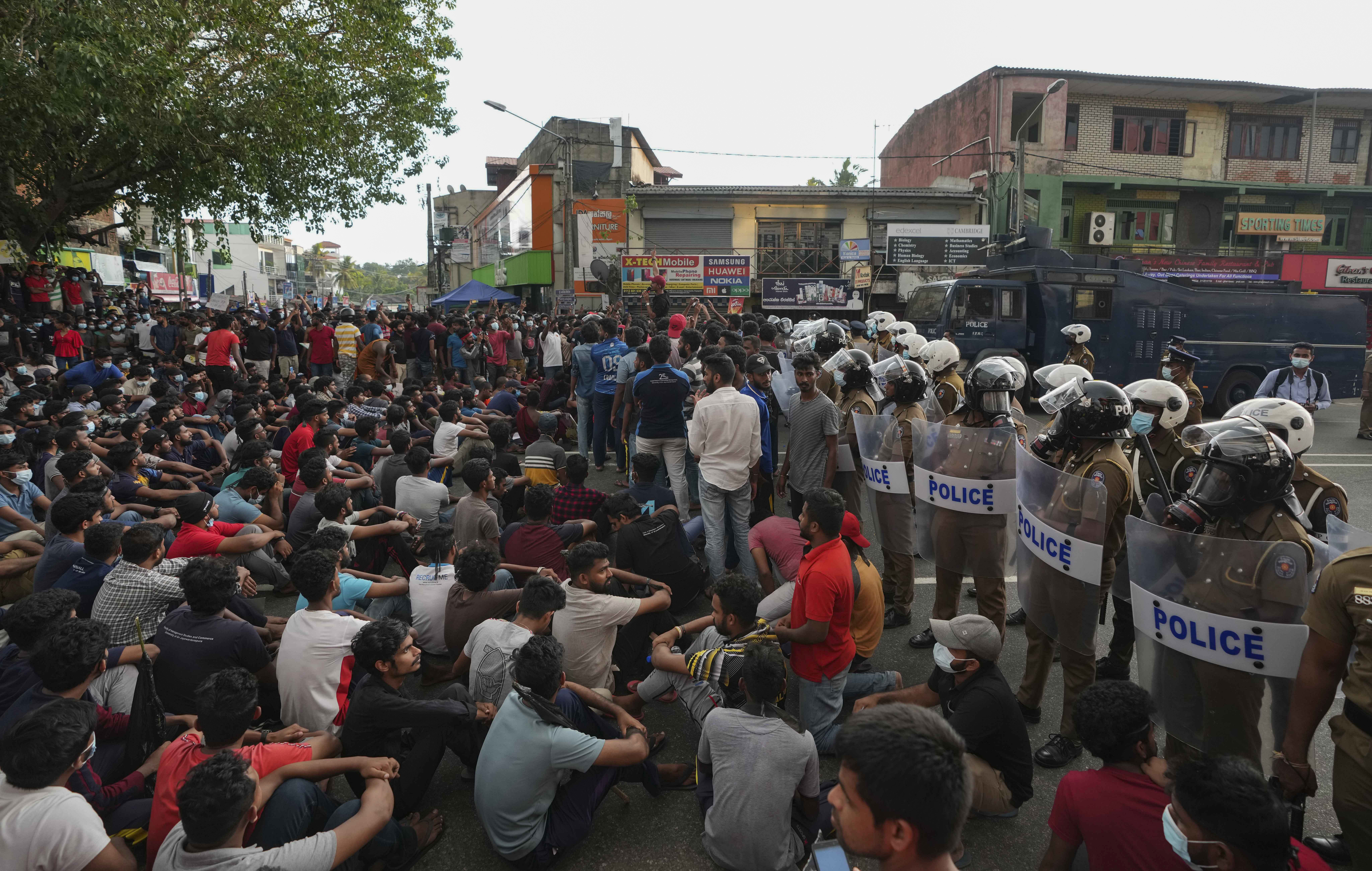 Sri Lankan undergraduates protest blocking a highway demanding the government step down during a curfew in Colombo, Sri Lanka