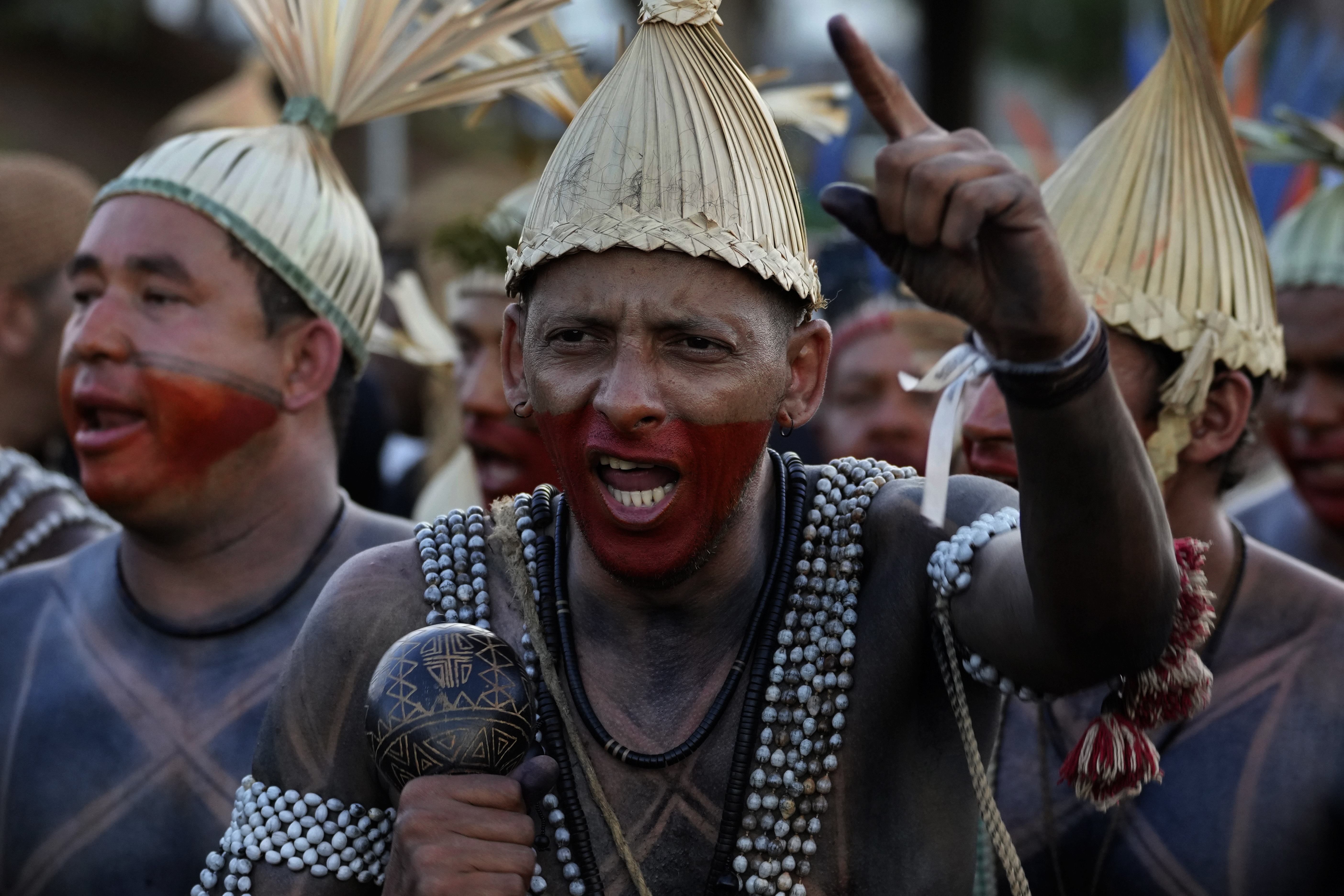 A Xukuru Indigenous man performs during the March